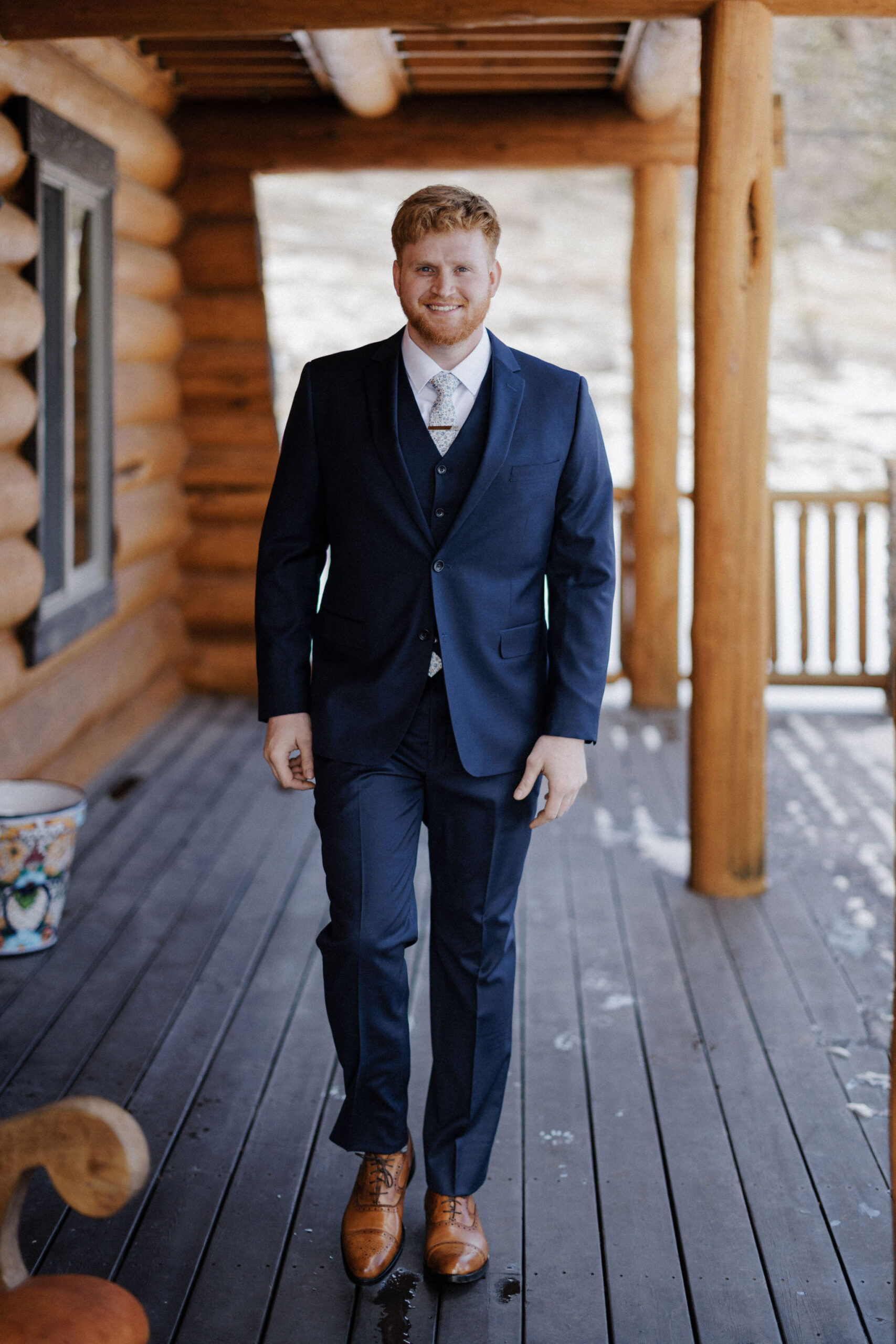 groom walks around airbnb during wedding photos with photographer