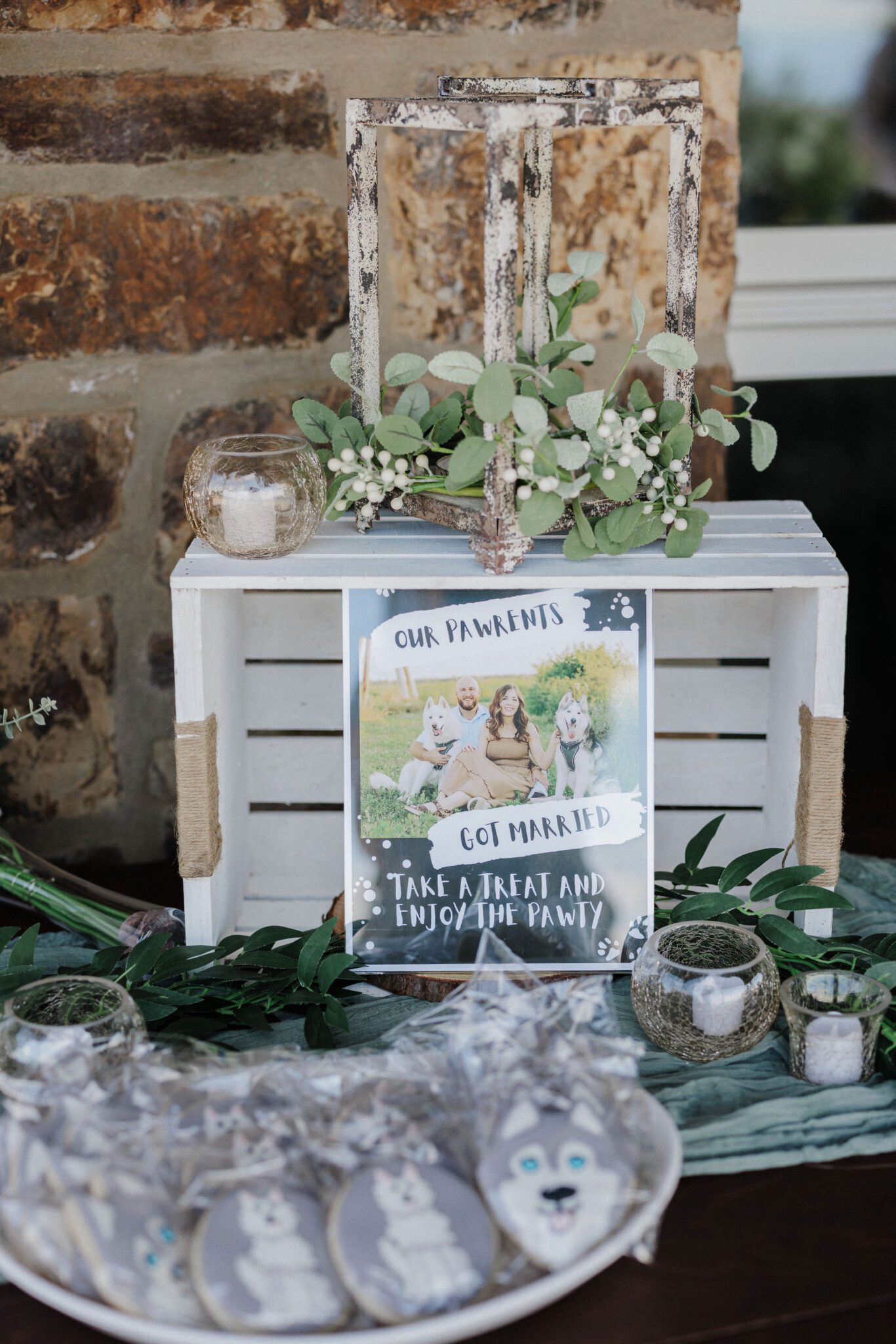 wedding signage and cookies sit on table during colorado elopement with dog