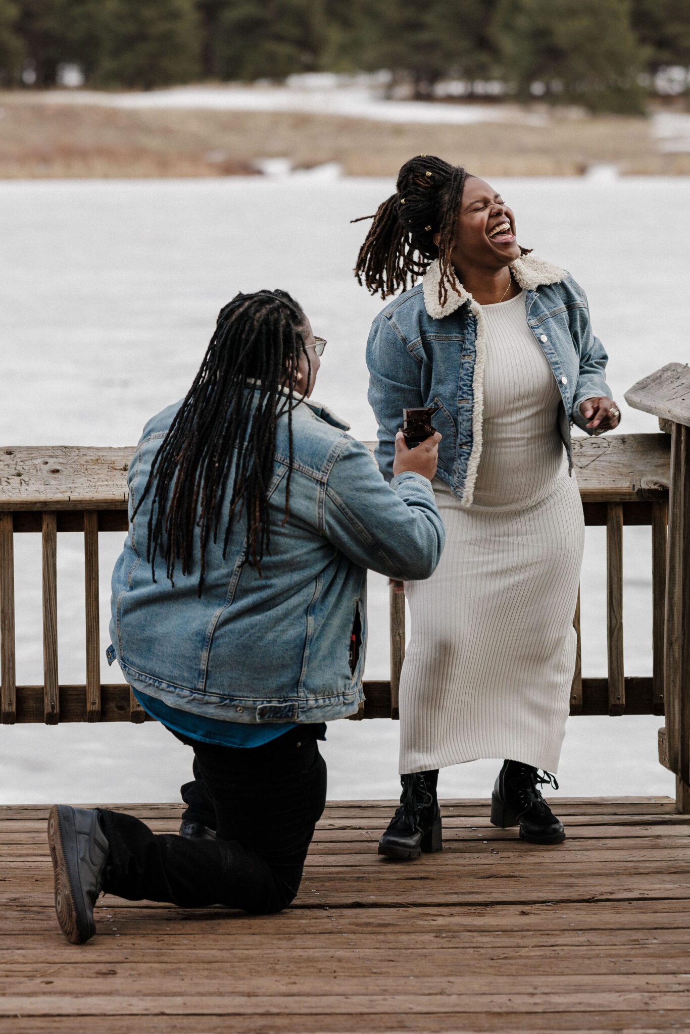 woman gets down on knee and proposes to girlfriend during colorado proposal in the mountains