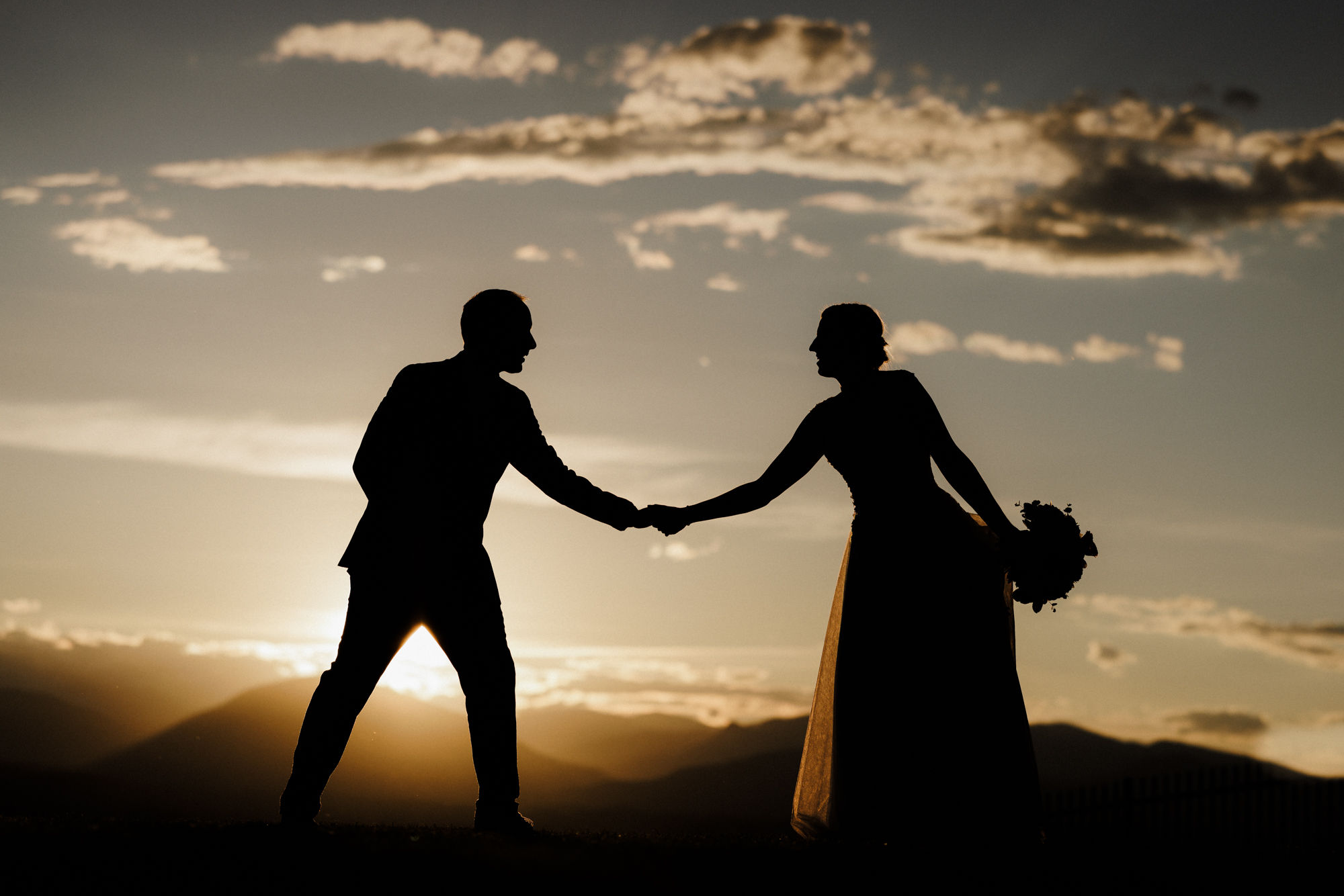 bride and groom pose for sunset wedding photos