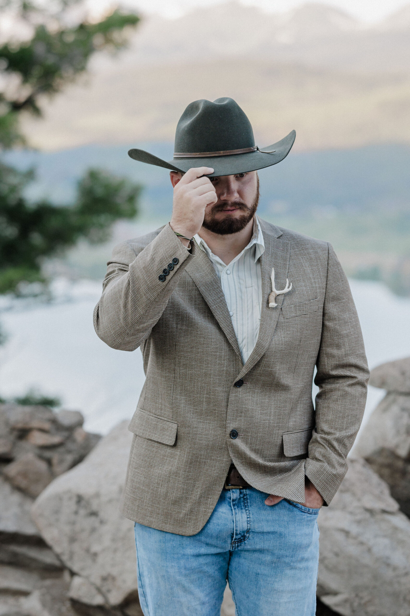 groom poses for colorado photographer during sunrise elopement in breckenridge