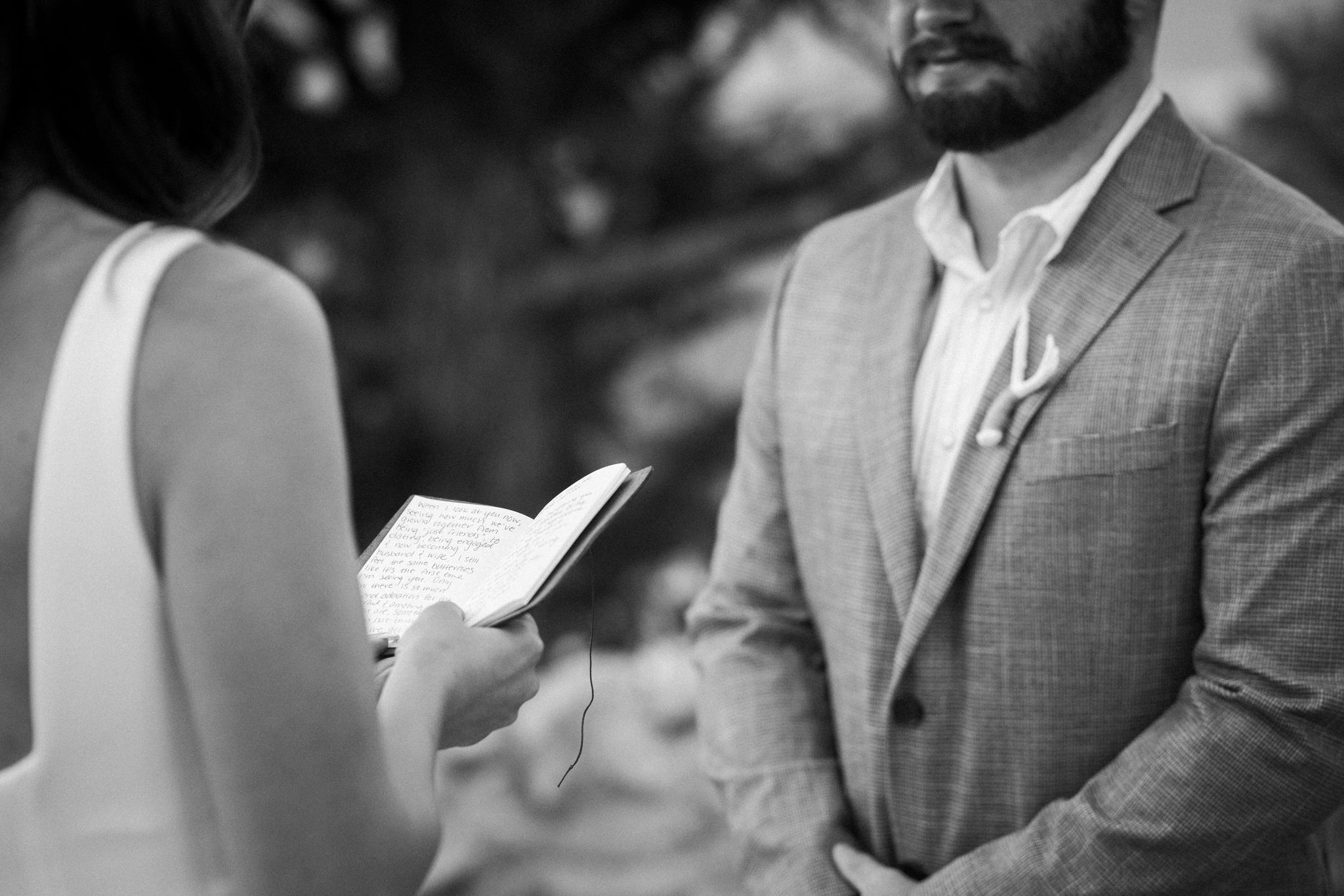 bride and groom read handwritten vows during elopement ceremony