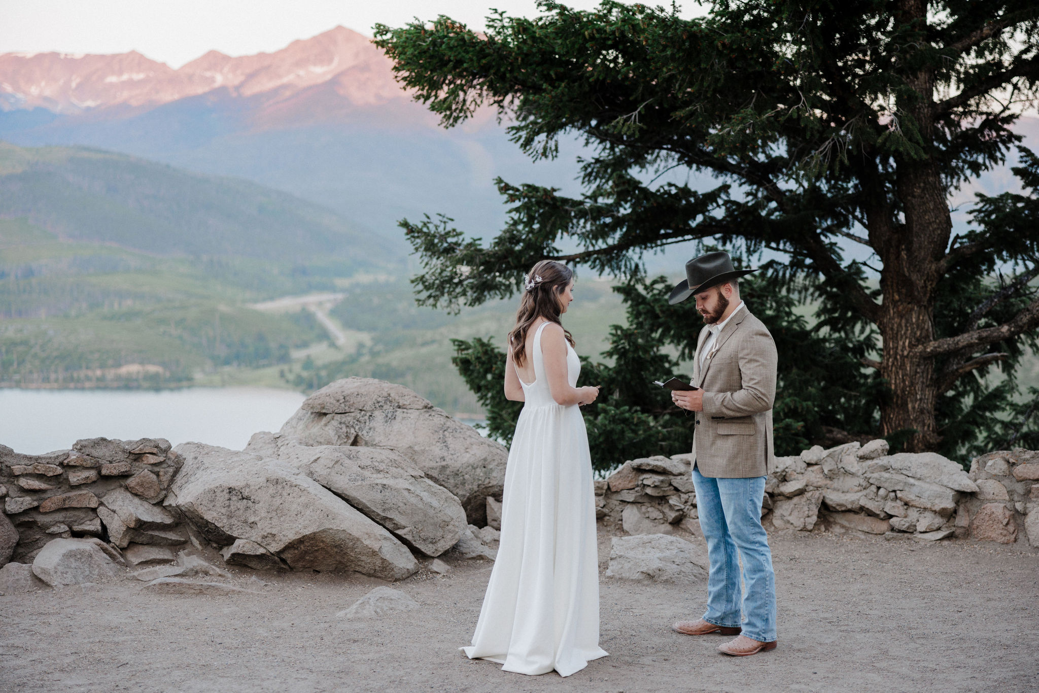 groom reads wedding vows to bride during sunrise elopement at sapphire point overlook