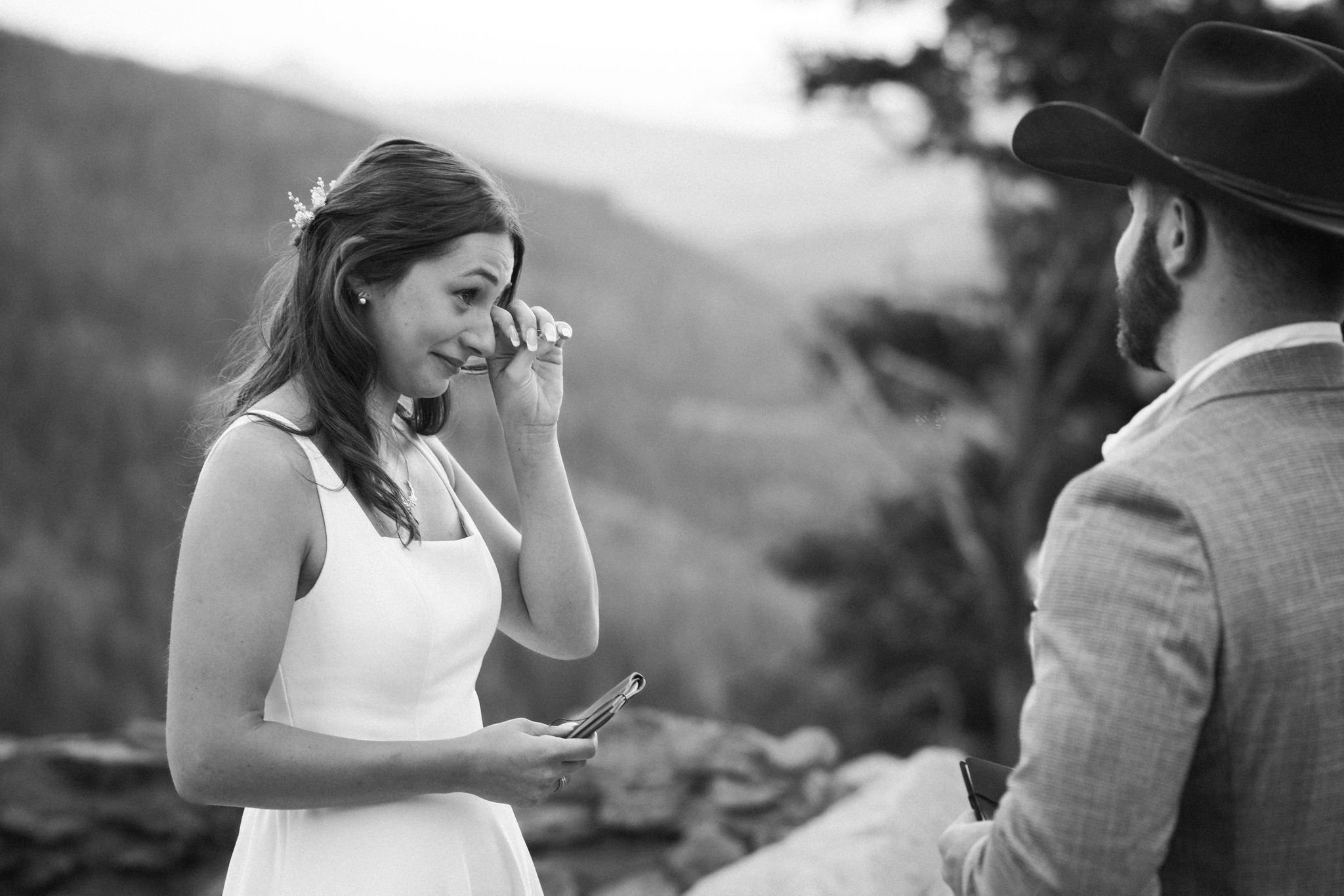 bride wipes tears from her face during emotional elopement ceremony