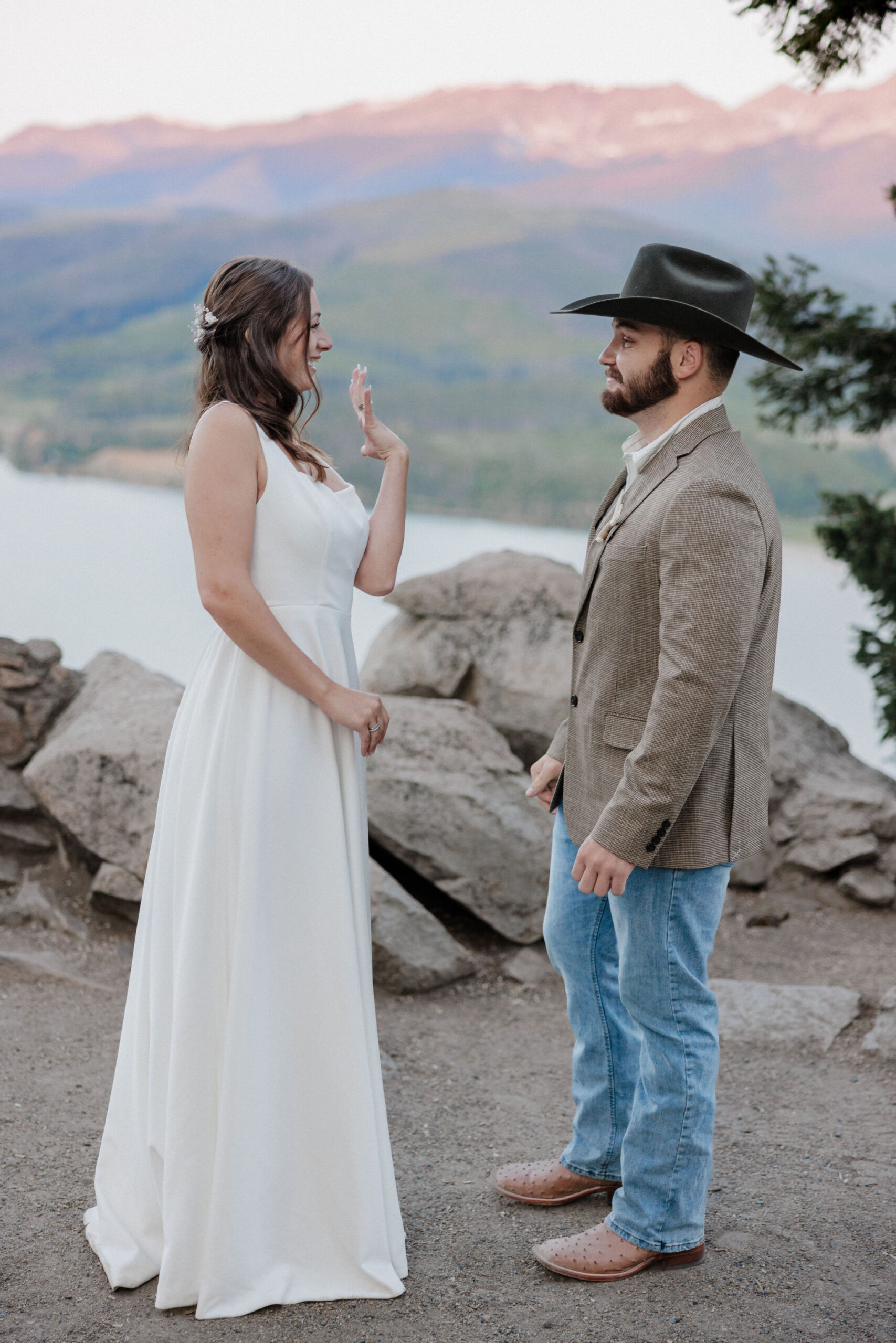 bride shows off wedding ring during sunrise elopement ceremony