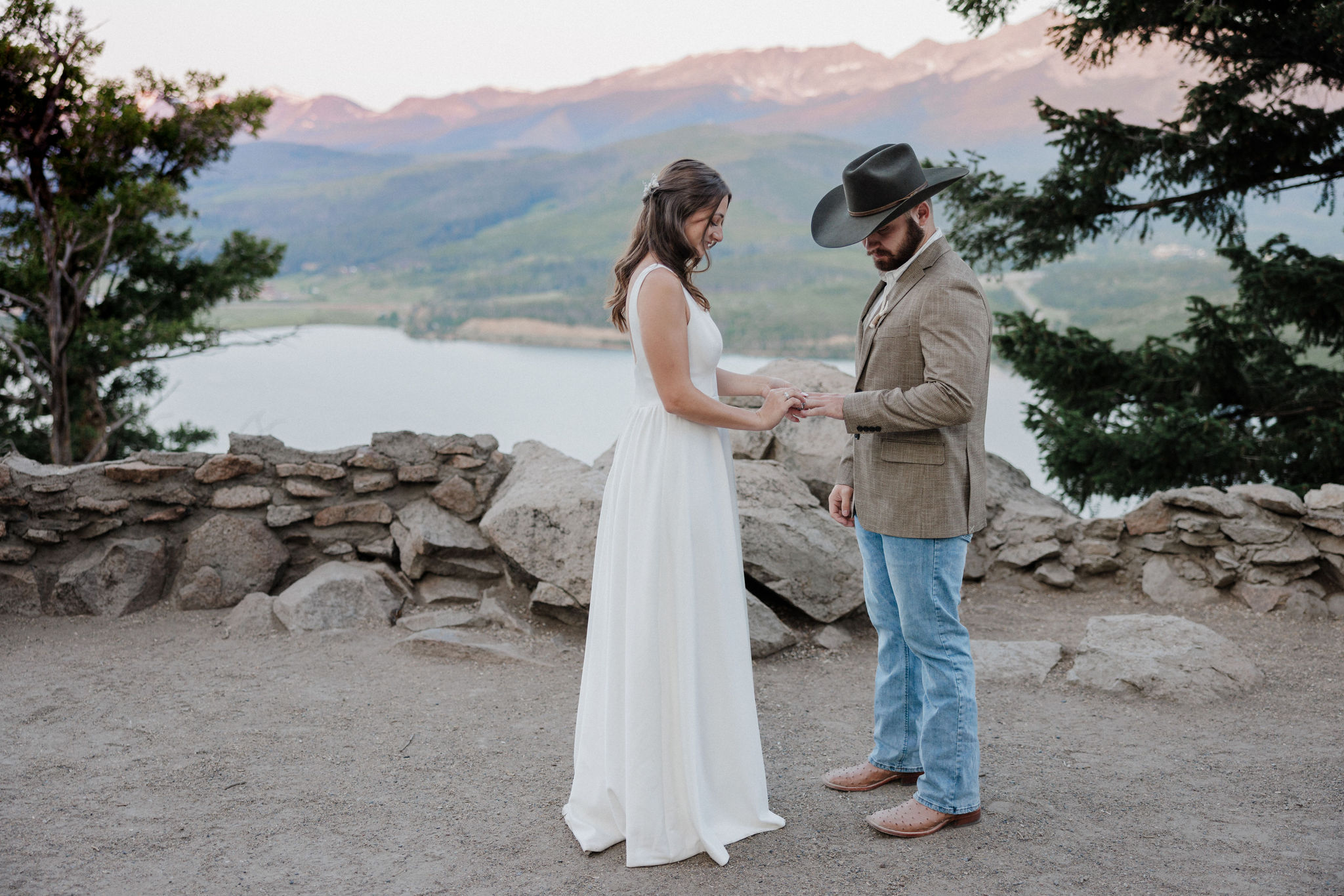 groom reads wedding vows to bride during sunrise elopement