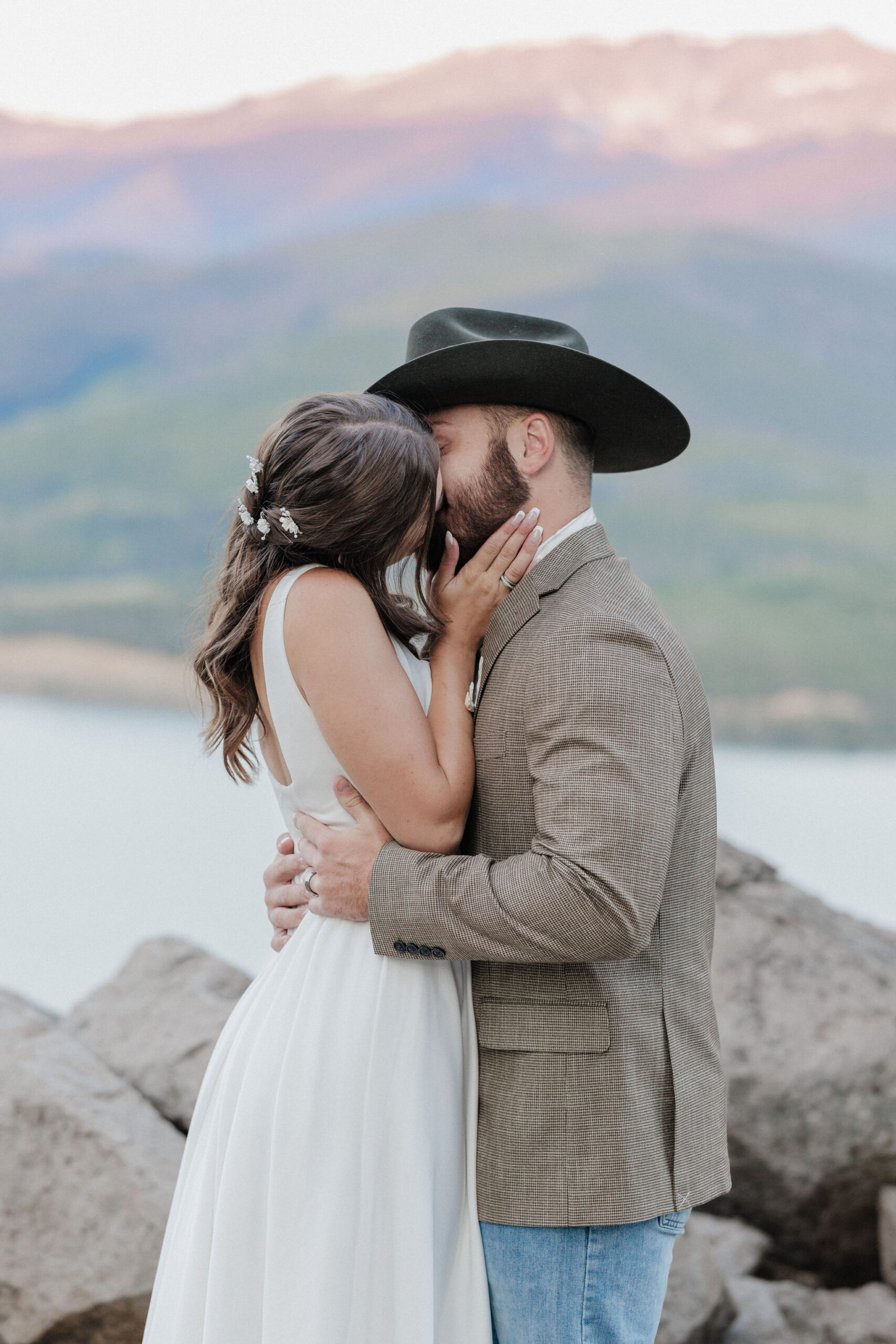 bride and groom kiss during sunrise elopement ceremony