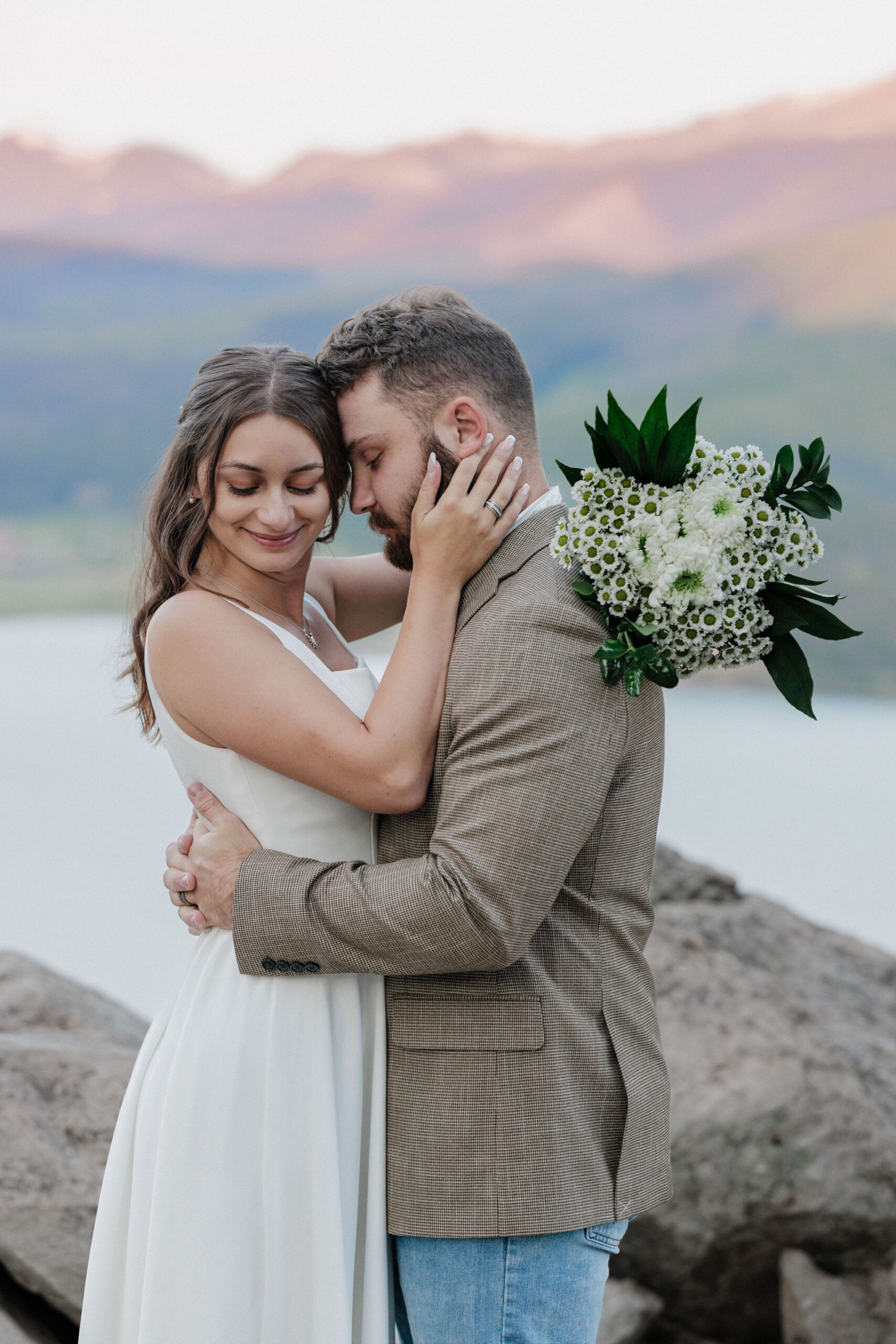 bride and groom pose for colorado photographer during sunrise elopement in breckenridge colorado