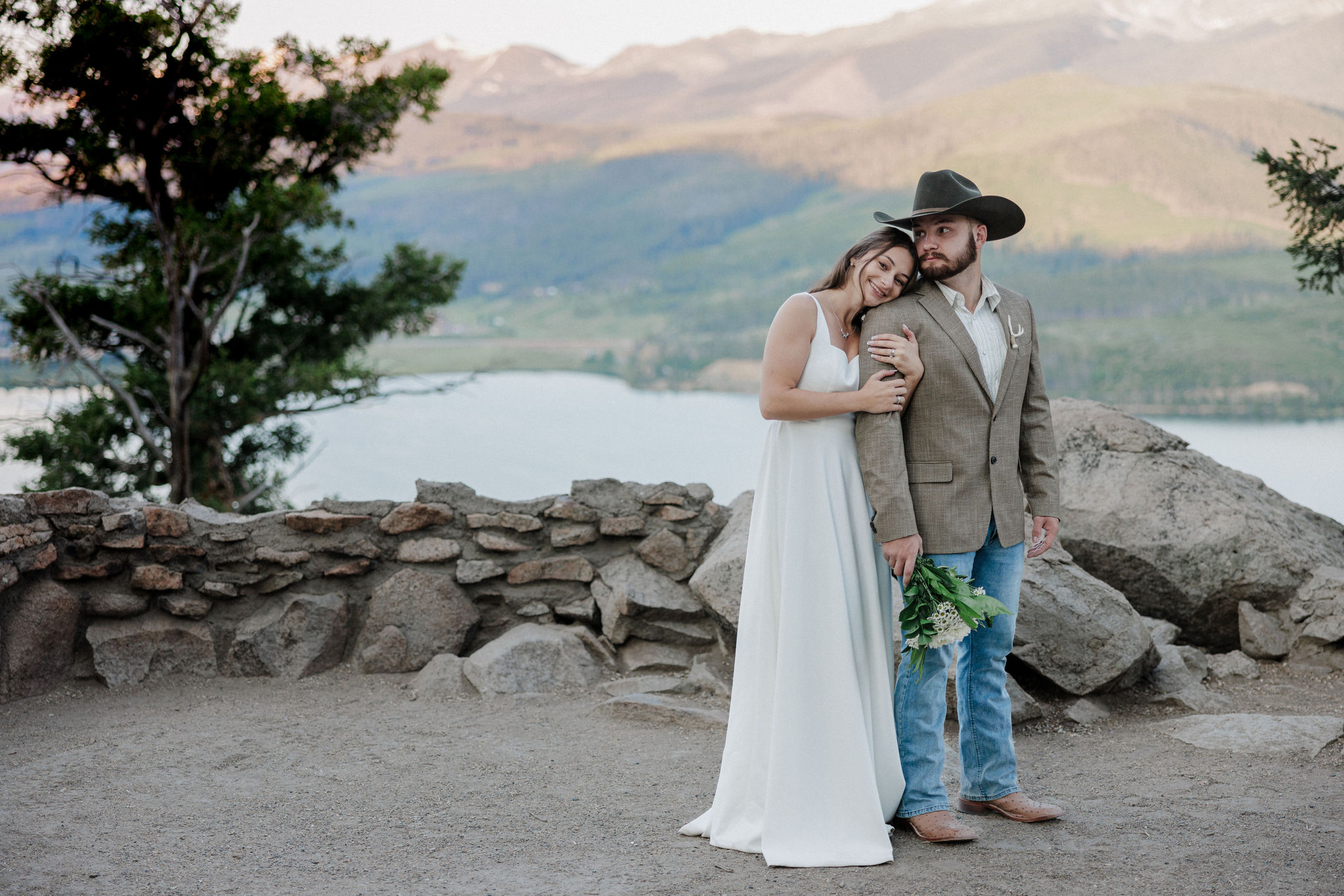 bride leans head on grooms shoulder during sunrise elopement ceremony