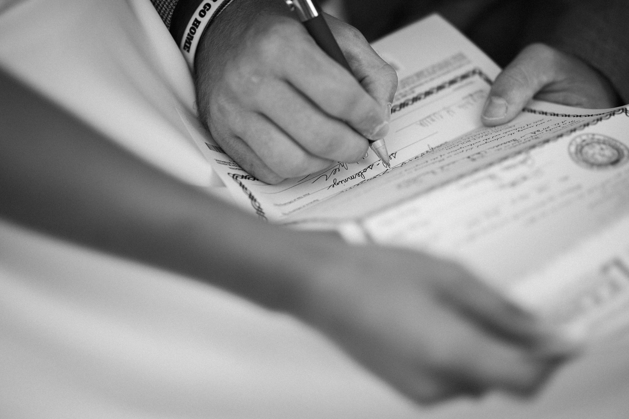 close up image of marriage license being signed