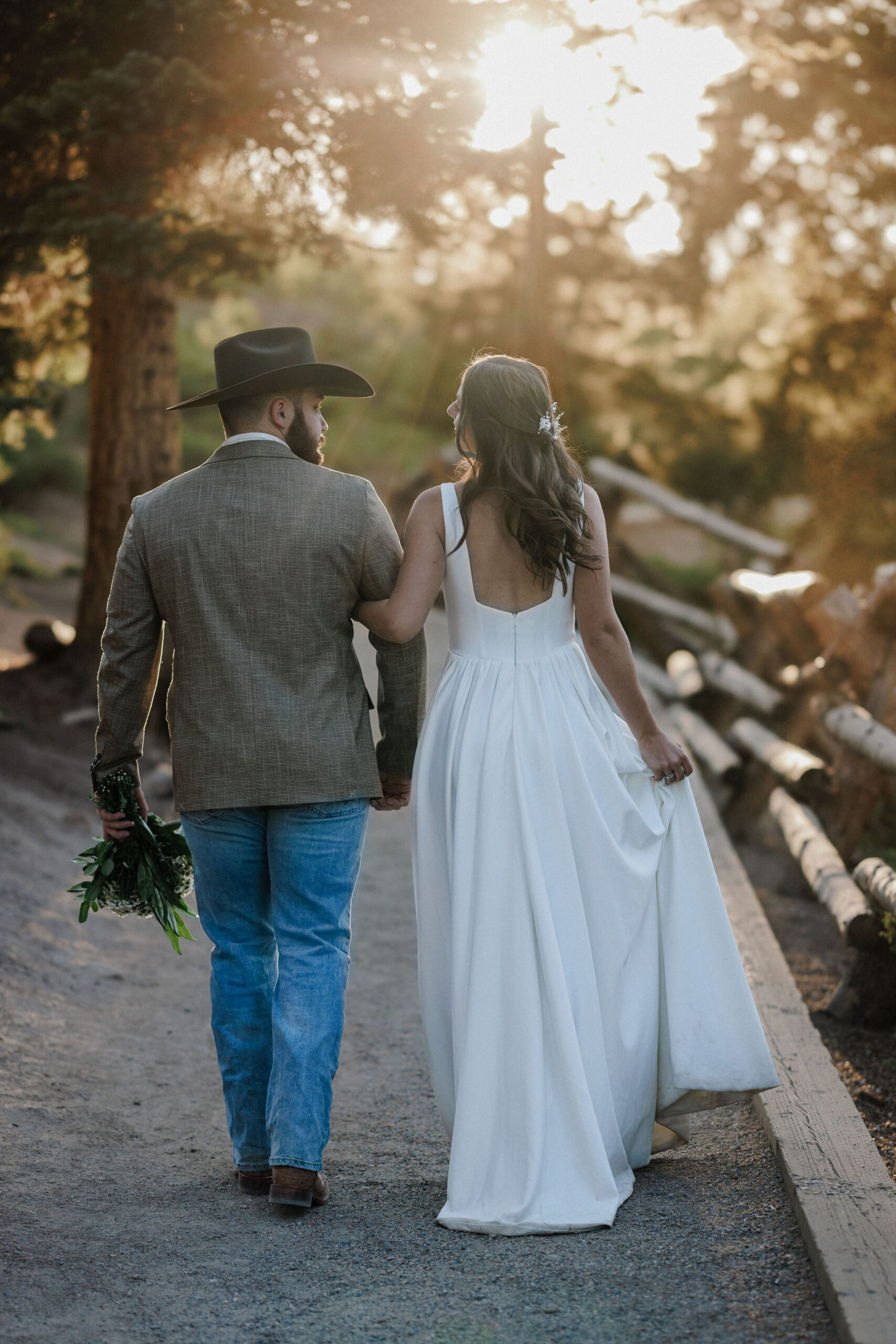 bride and groom walk along trail in breckenridge during sunrise elopement