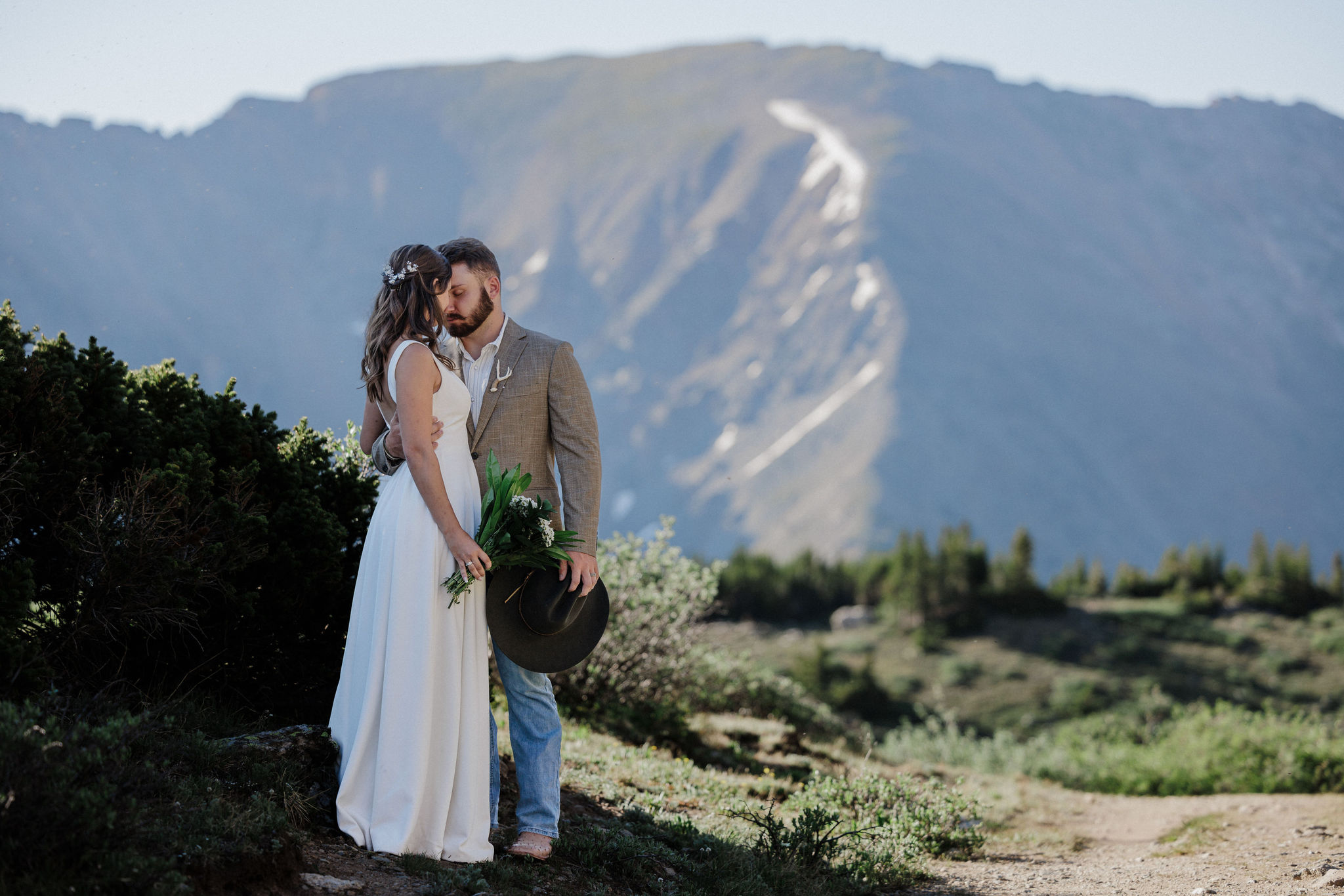 during sunrise elopement in breckenridge, bride and groom pause to spend quality time