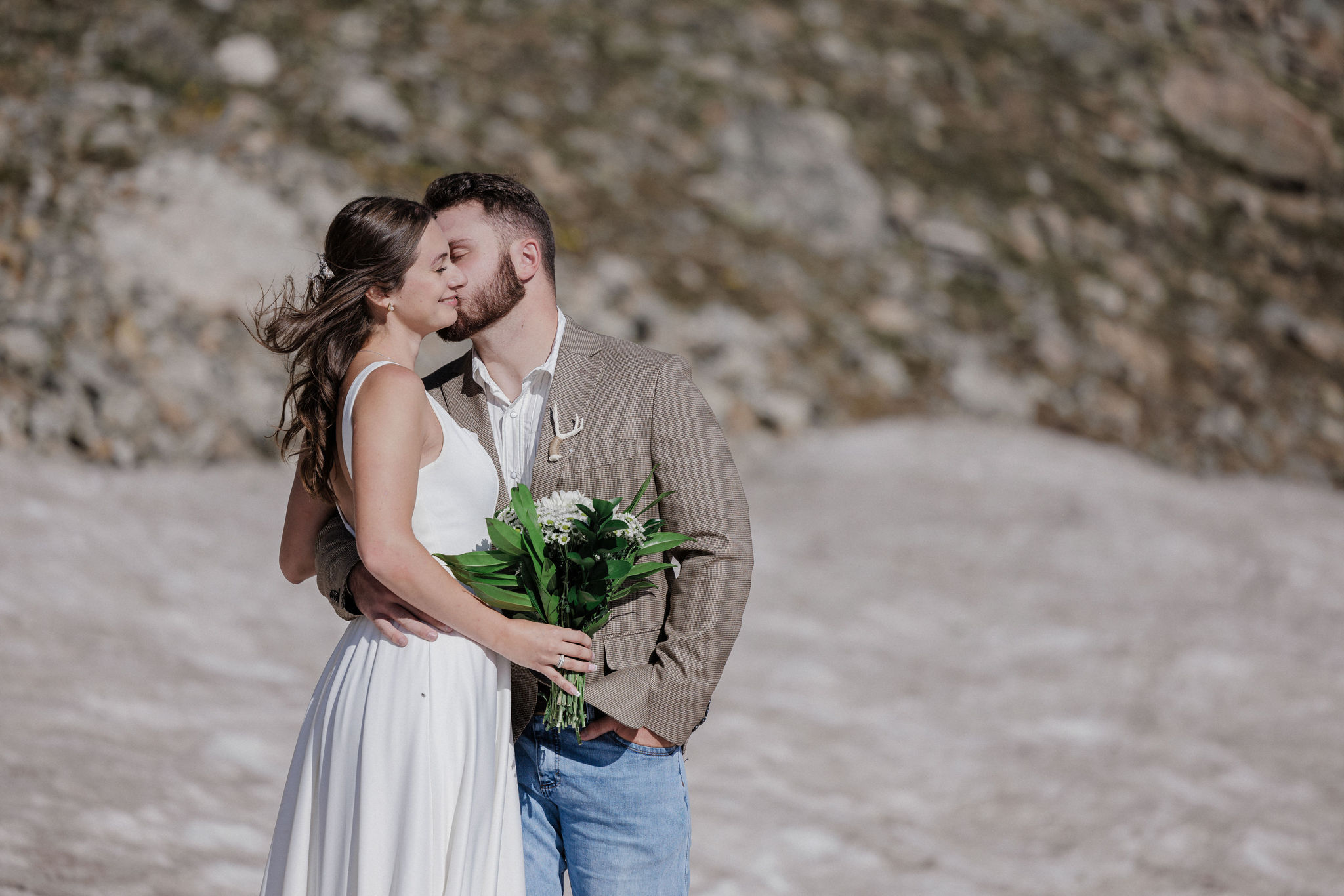 groom kisses brides cheek during wedding photos in breckenridge