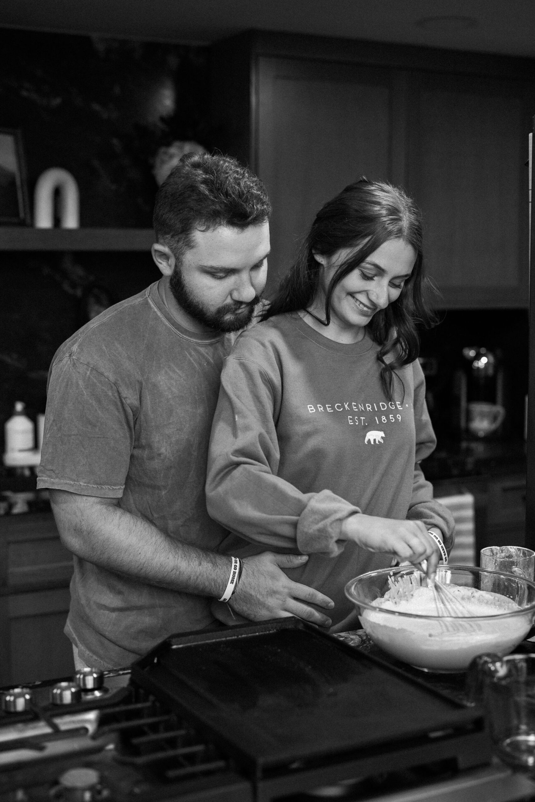 bride and groom stir pancake mix as they make breakfast after their sunrise elopement ceremony