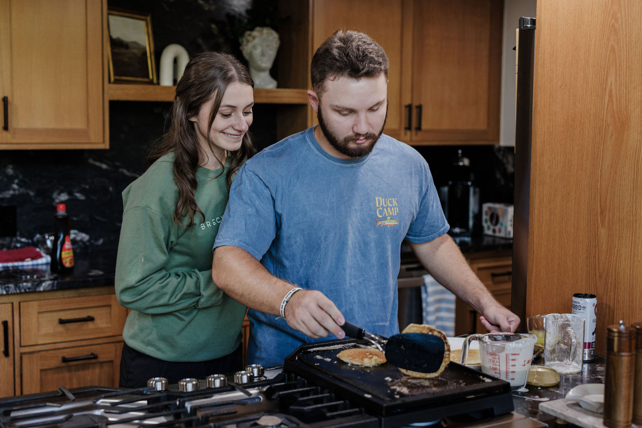 bride and groom cook pancakes after colorado elopement ceremony