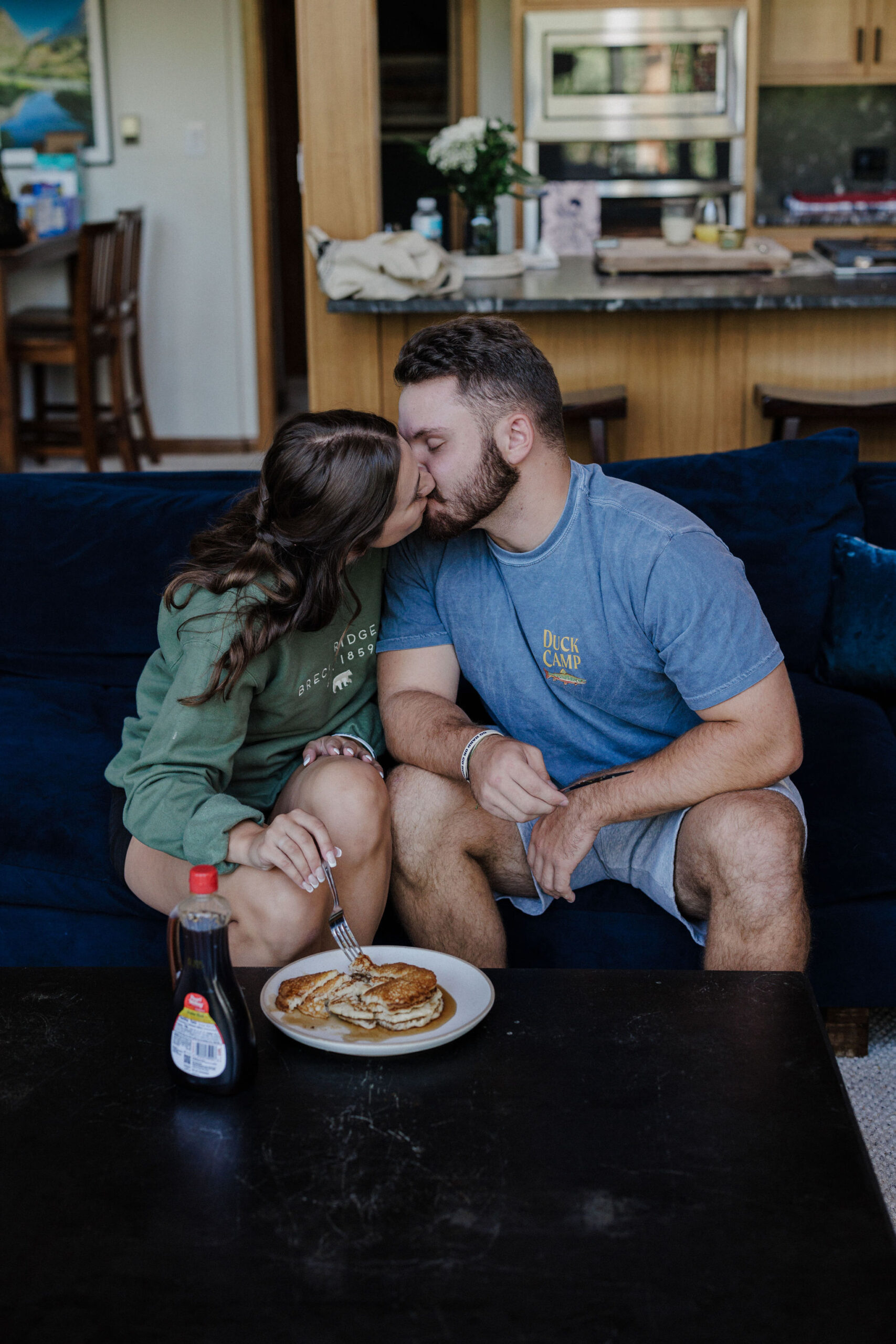 bride and groom kiss during post-elopement pancake breakfast