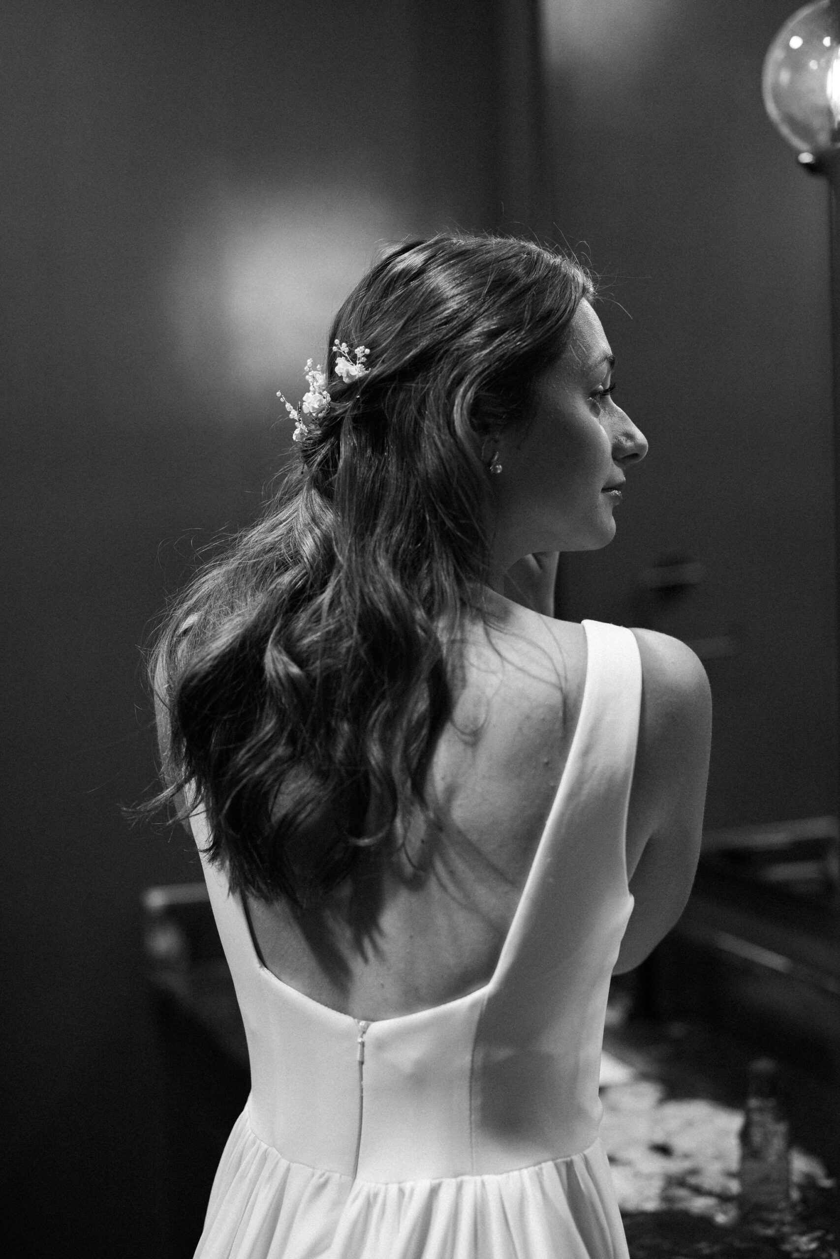 bride puts earrings on during getting ready moments of her elopement day in colorado airbnb