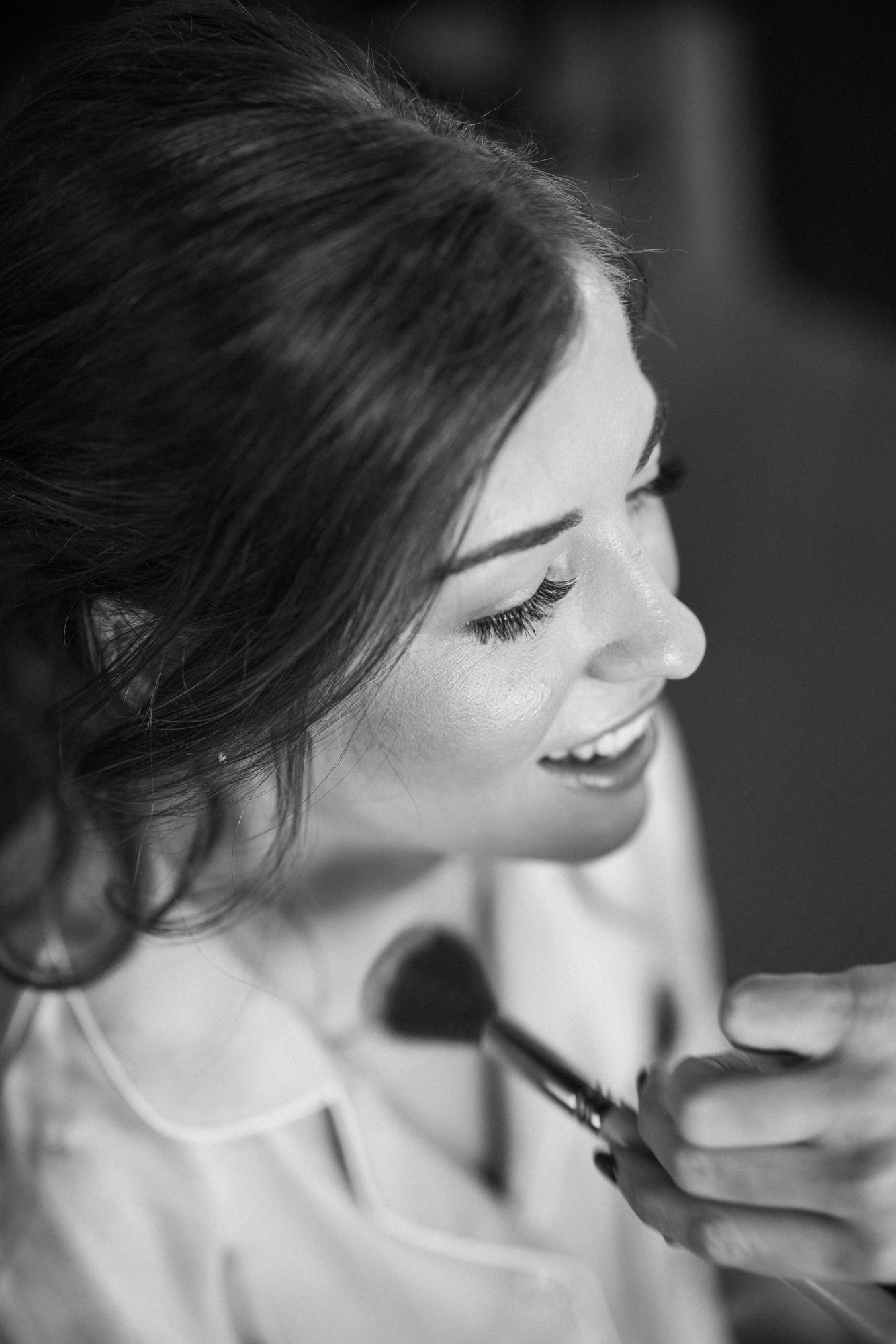 bride gets her makeup put on while getting ready for her aspen colorado micro wedding