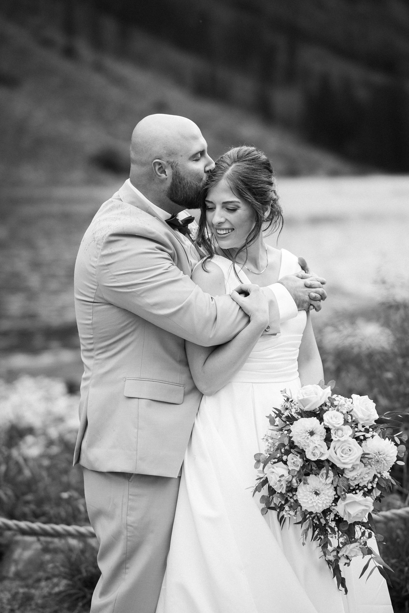 bride and groom pose for colorado wedding photographer at maroon bells in aspen