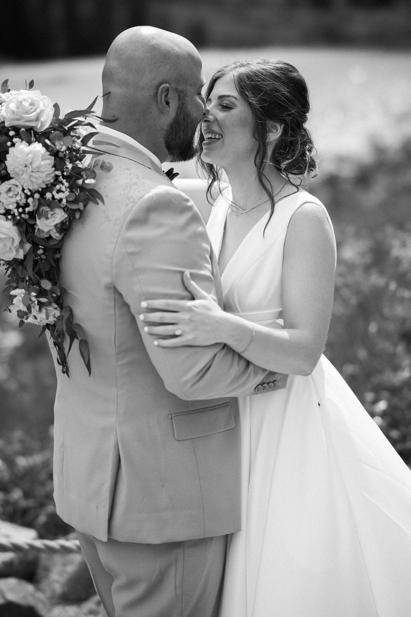 bride and groom go in for a kiss during wedding portraits at maroon bells in aspen colorado