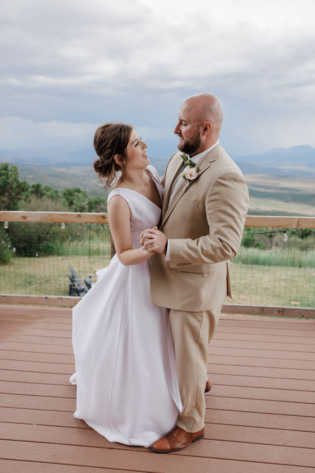 bride and groom dance on the deck of a colorado airbnb wedding venue