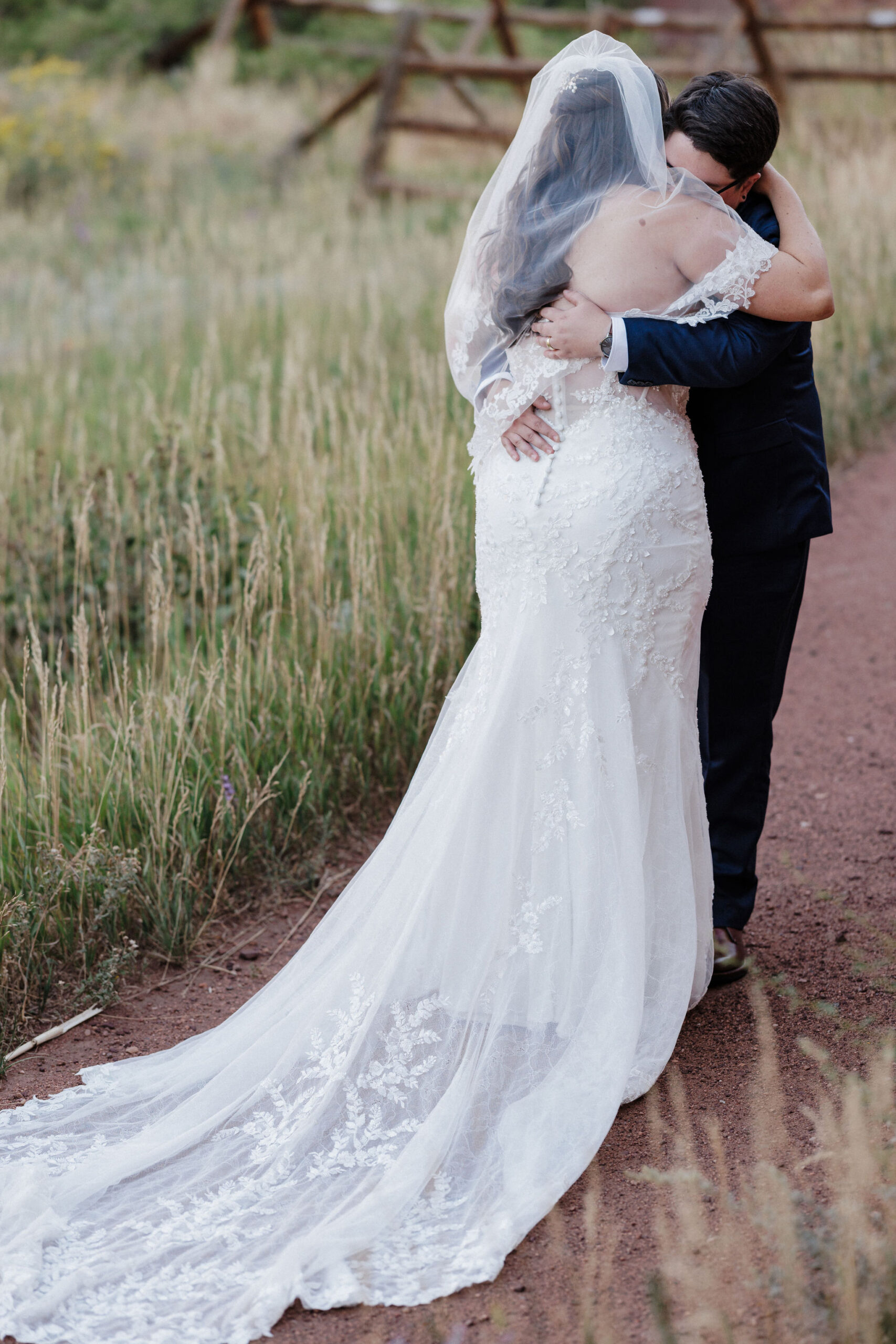 lgbtq+ couple hugs after wedding day first look at red rocks park