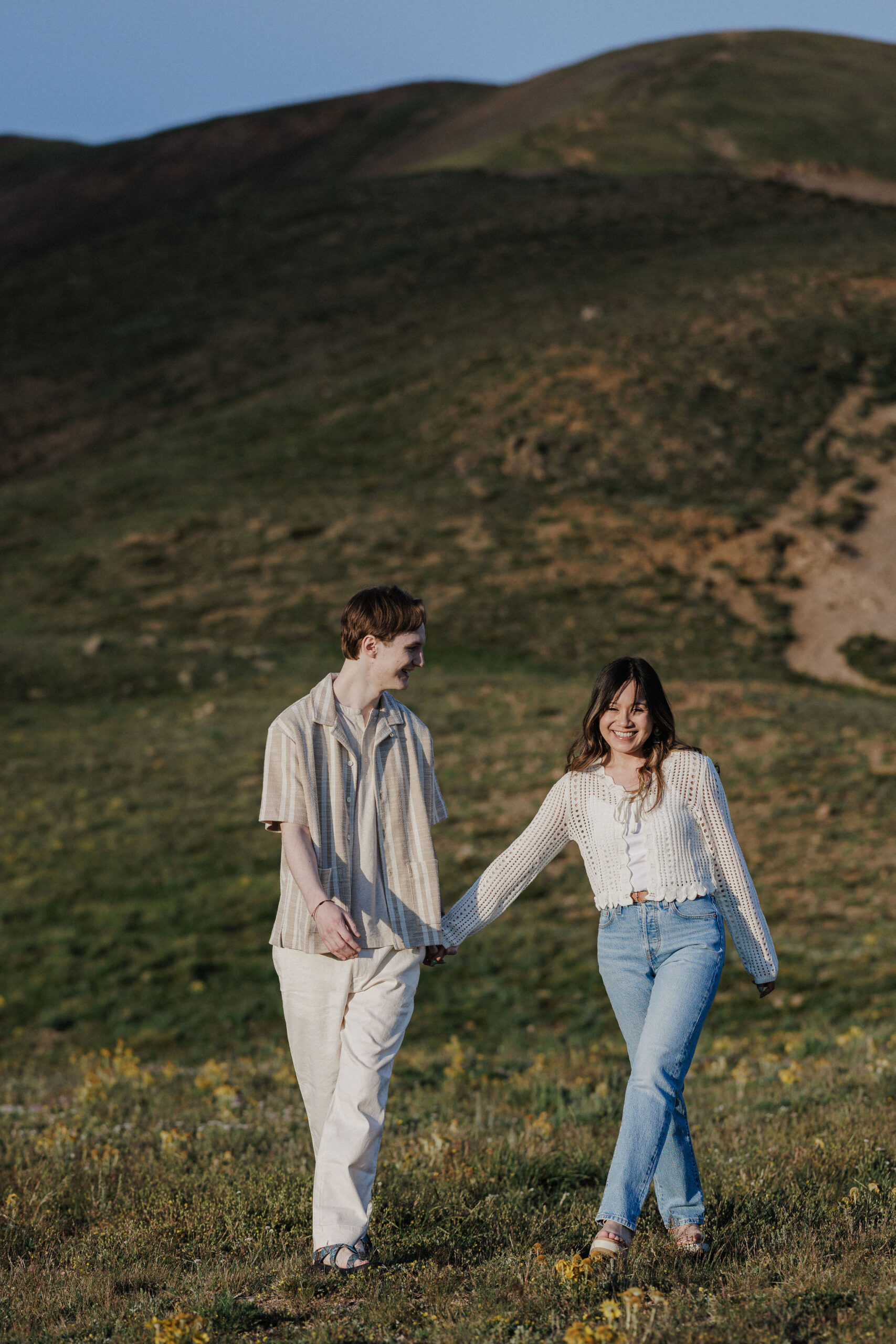 man and woman pose for colorado engagement photographer