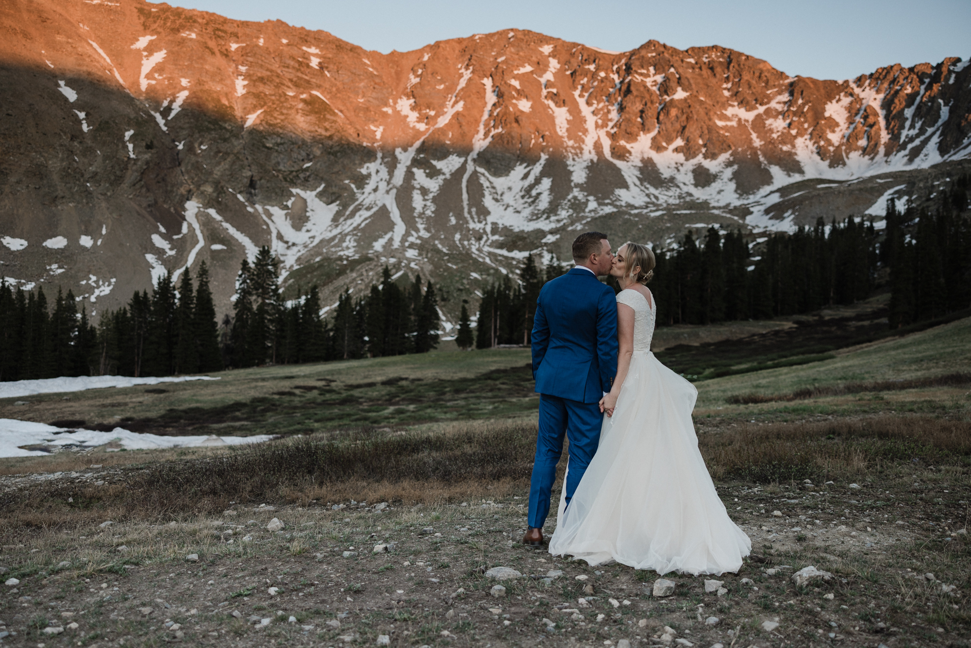 bride and groom kiss during sunset in the mountains of breckenridge during micro wedding