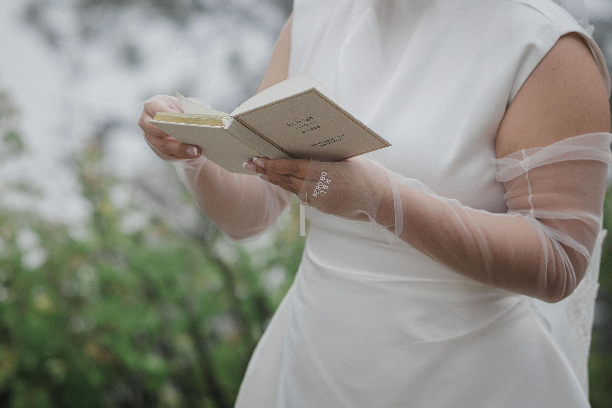 bride holds wedding vow book during boulder mountain elopement 