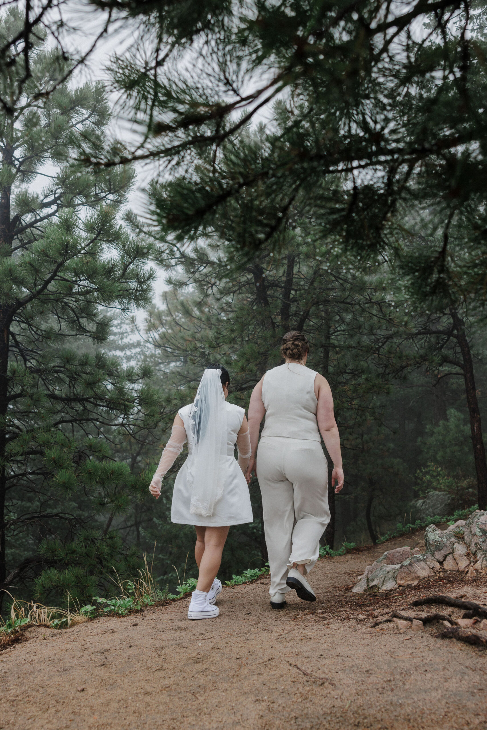 two brides walking on a trail