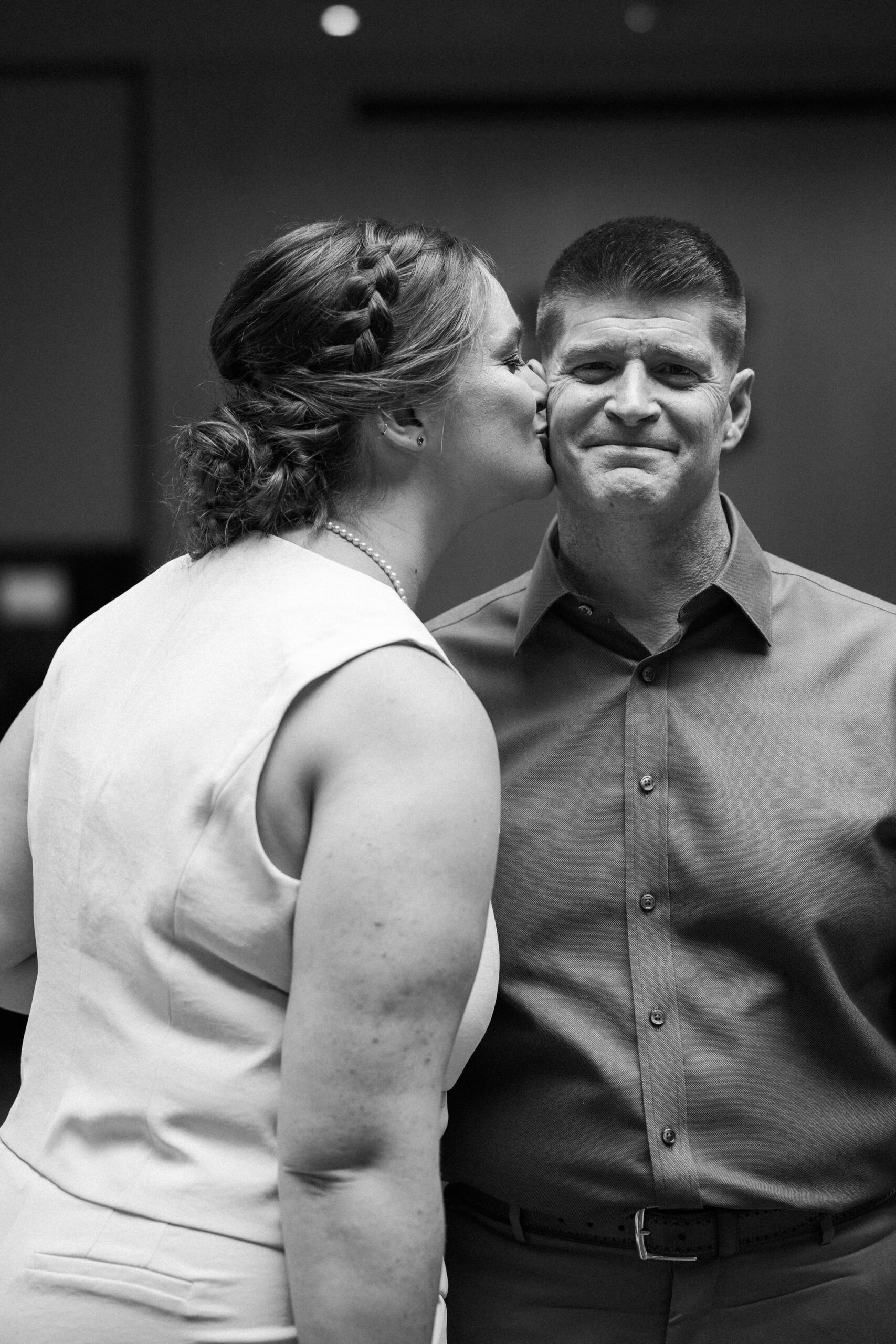 bride kisses father on the cheek after wedding day first look