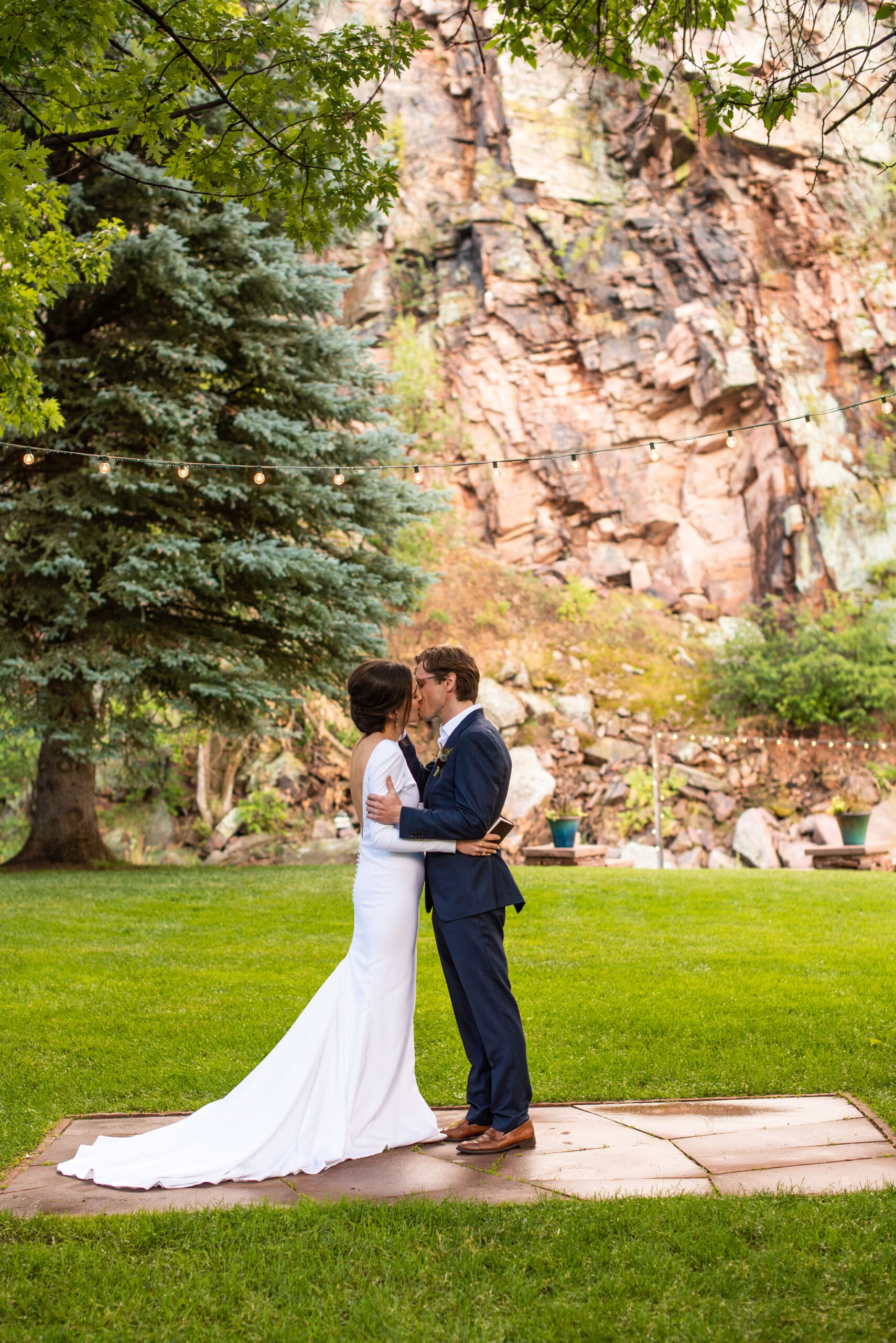 bride and groom kiss during wedding ceremony at estes park micro wedding venue