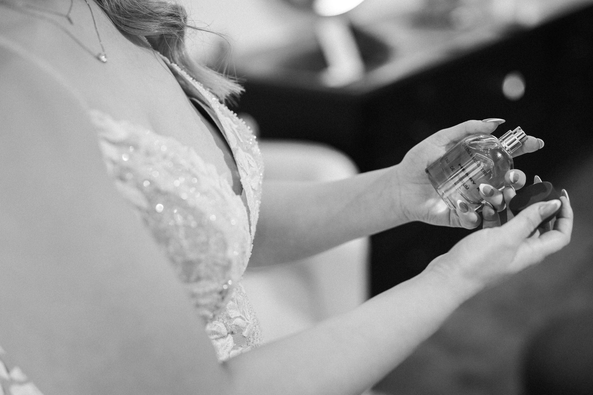 close up image of bride holding perfume