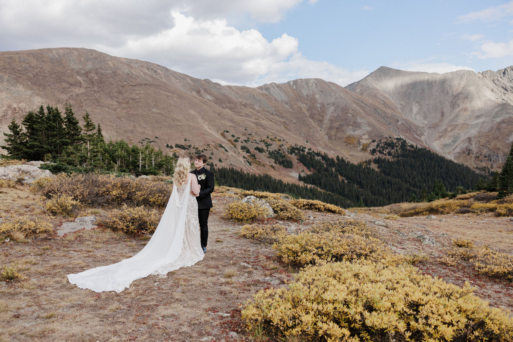 bride and groom hold hands during wedding day first look