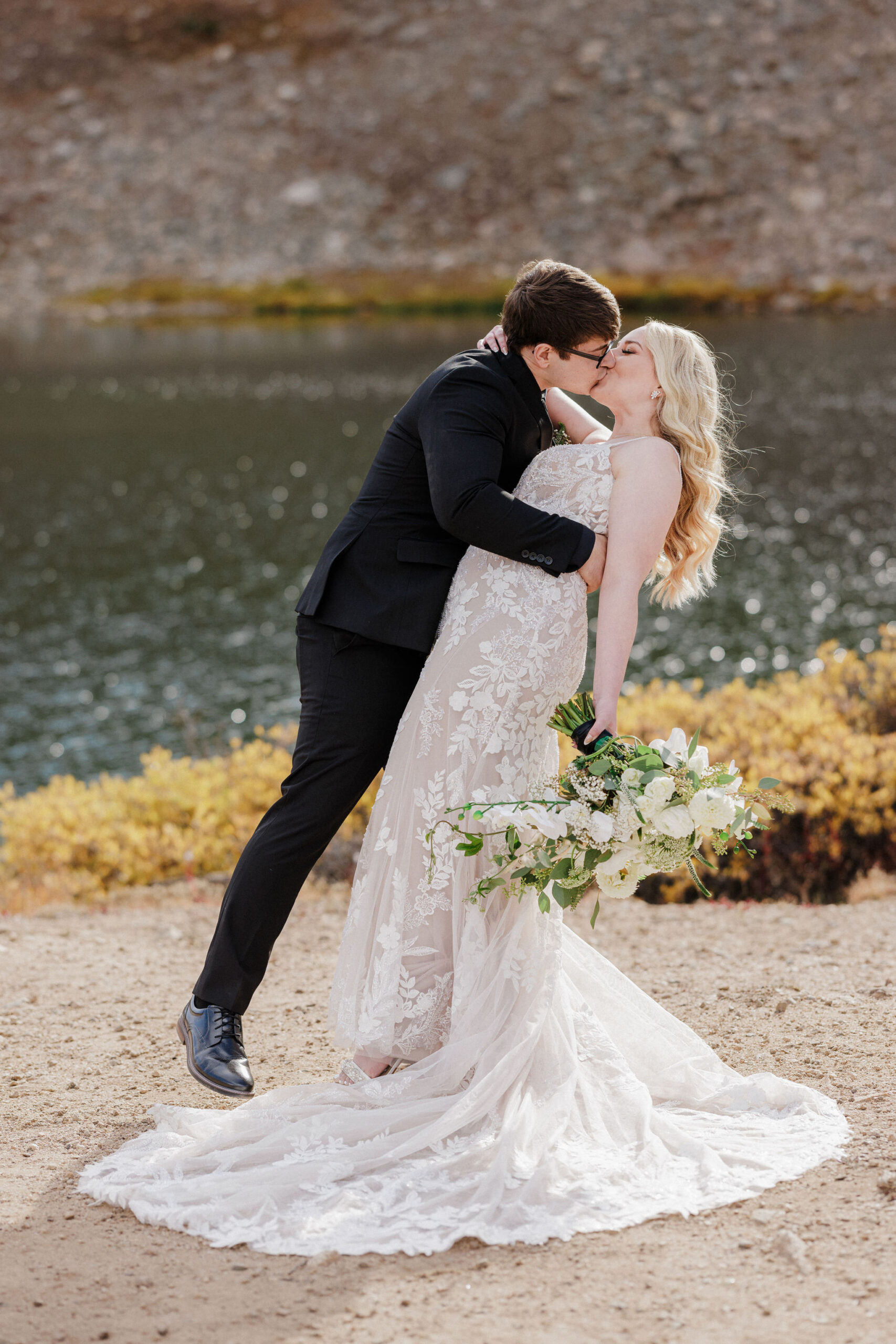 bride and groom kiss during colorado wedding photos