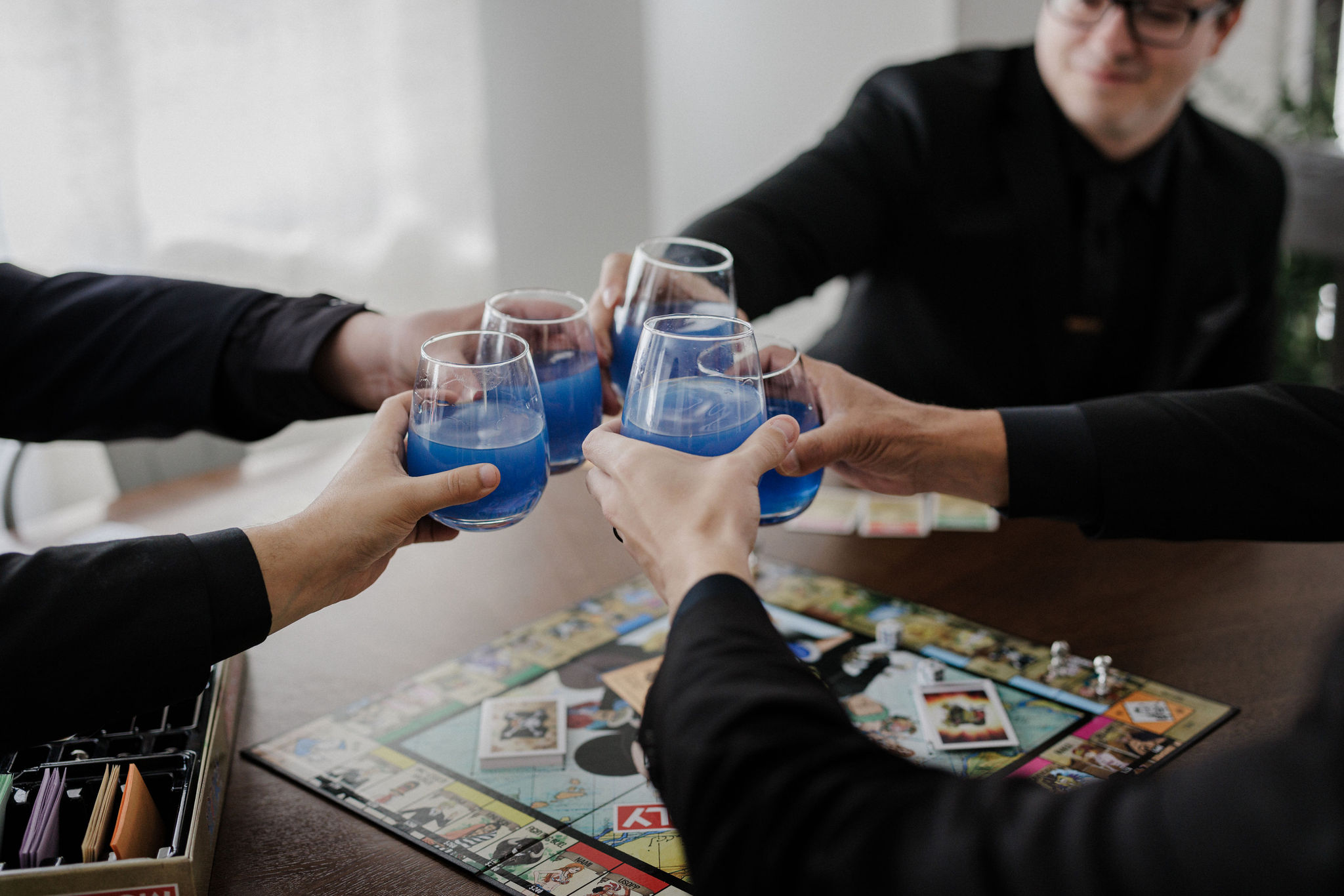 groomsman cheers blue drinks during wedding day