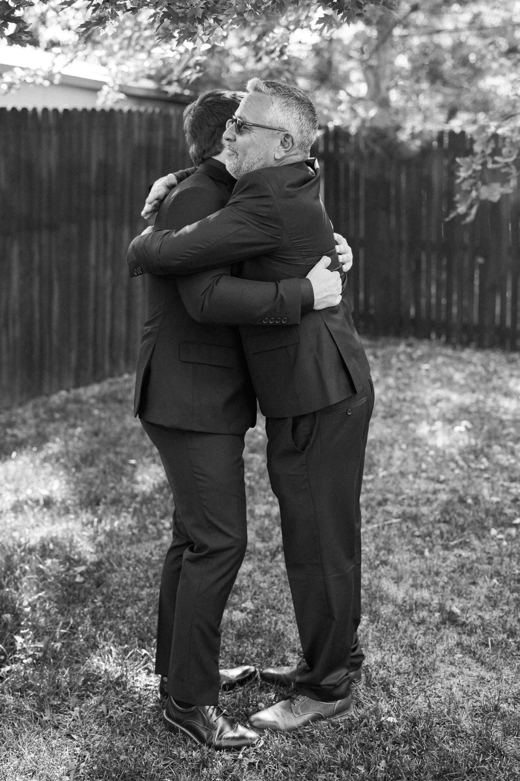 groom hugs father while getting ready for colorado wedding weekend