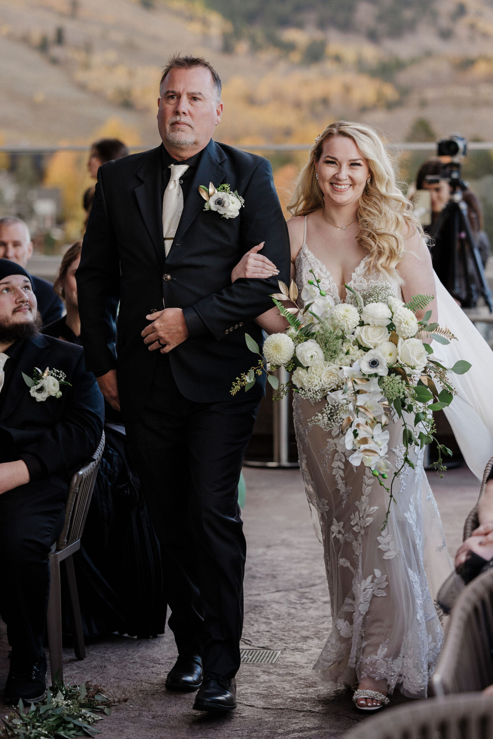 bride walks down the aisle with her father