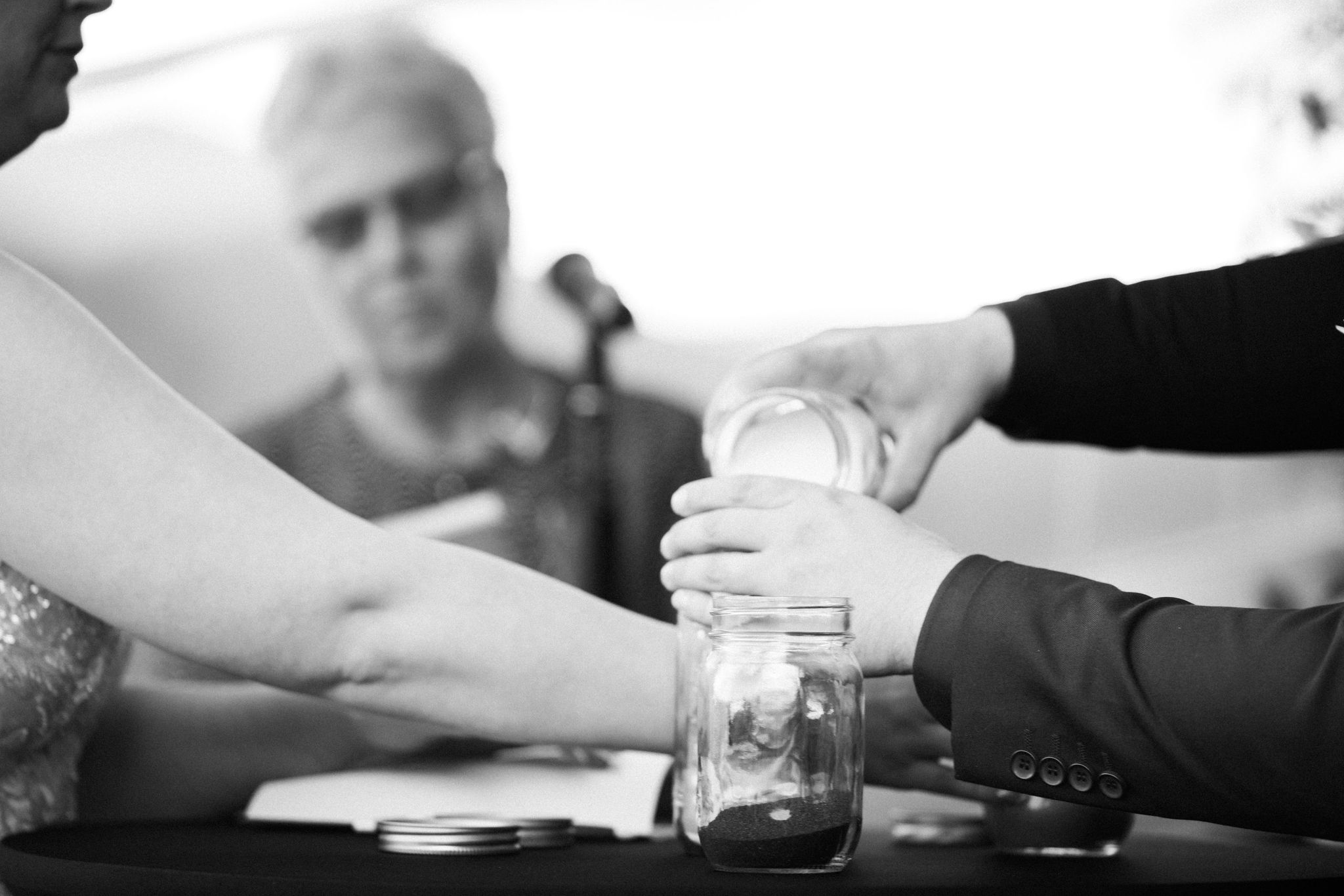 bride and groom do sand blending ceremony during micro wedding