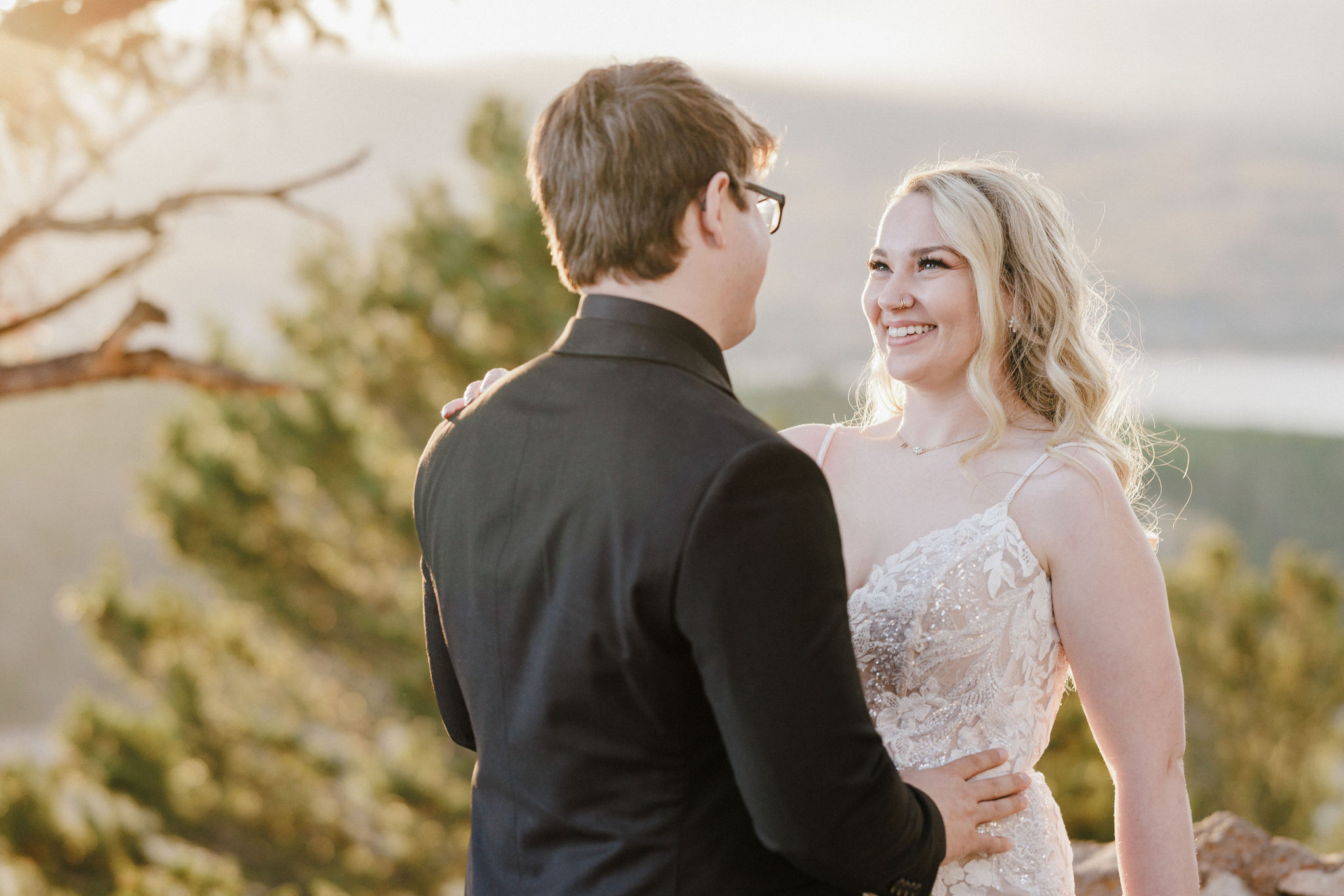 bride and groom smile at each other during colorado wedding photos