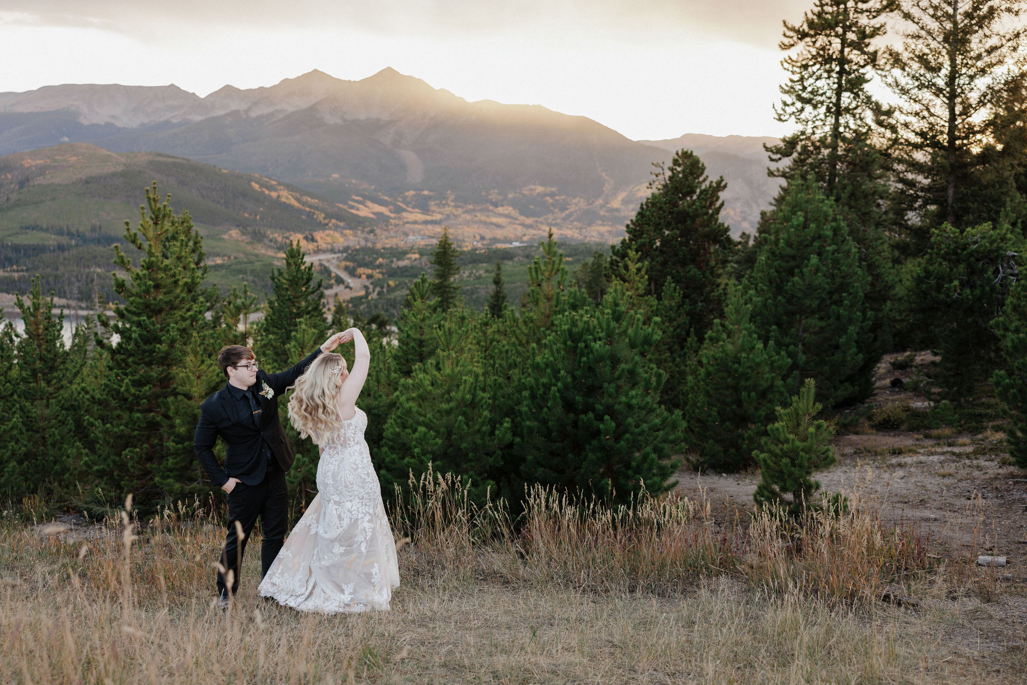 groom twirls bride during wedding weekend in breckenridge colorado