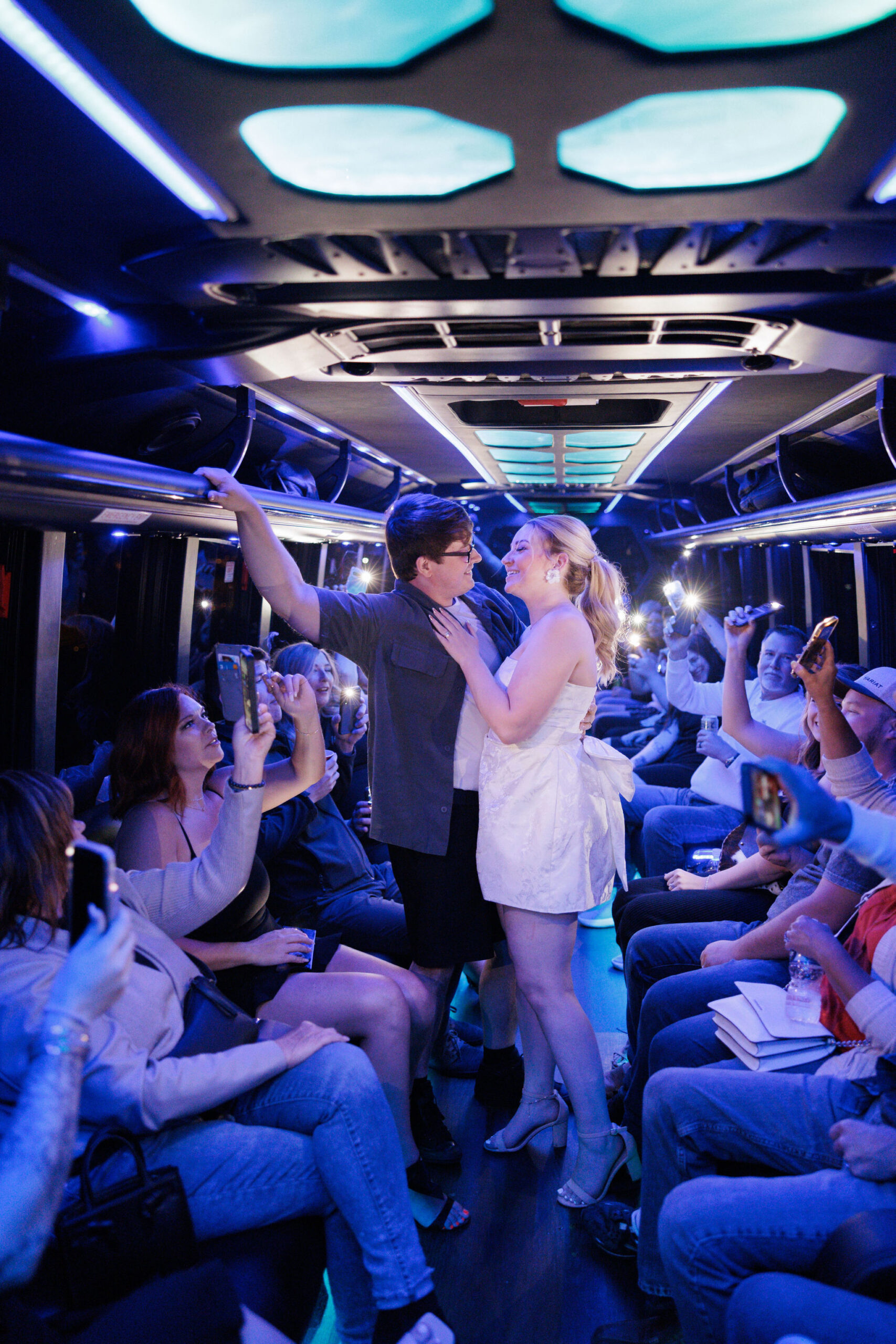 bride and groom smile on denver party bus