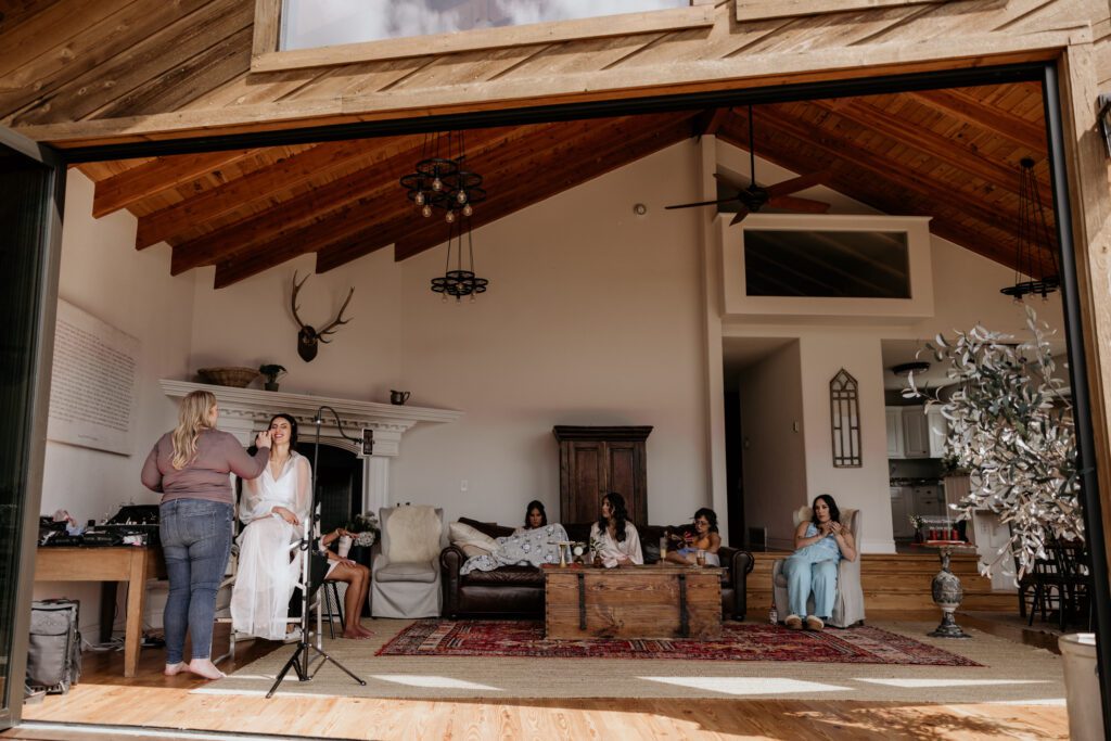 Bride gets ready in open air living room at Airbnb.