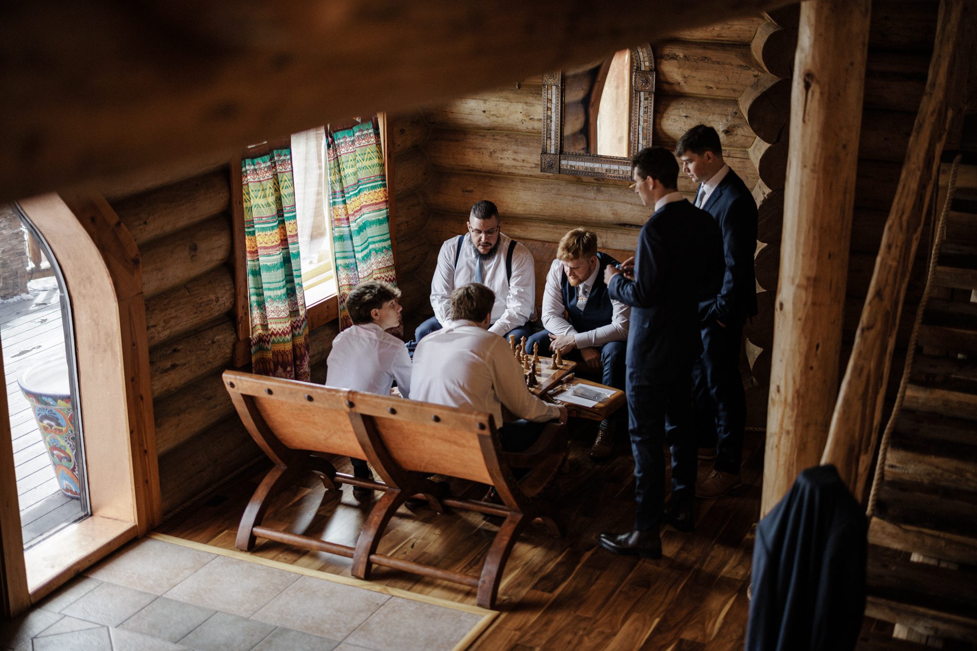 Groom and friends play chess leading up to Airbnb elopement.