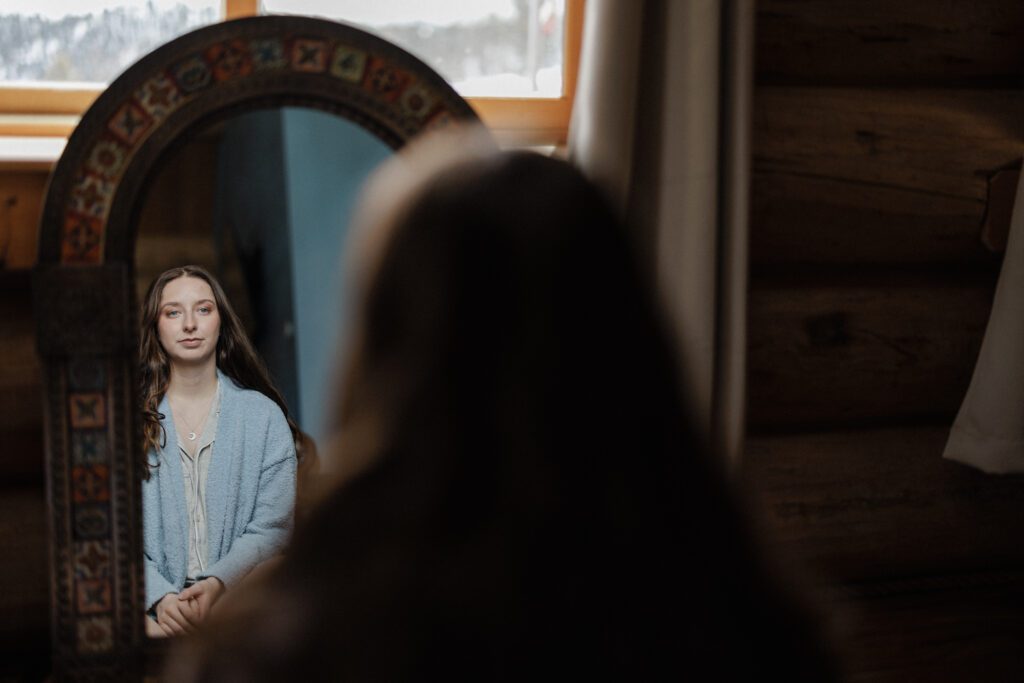 Bride gets ready during Airbnb elopement.