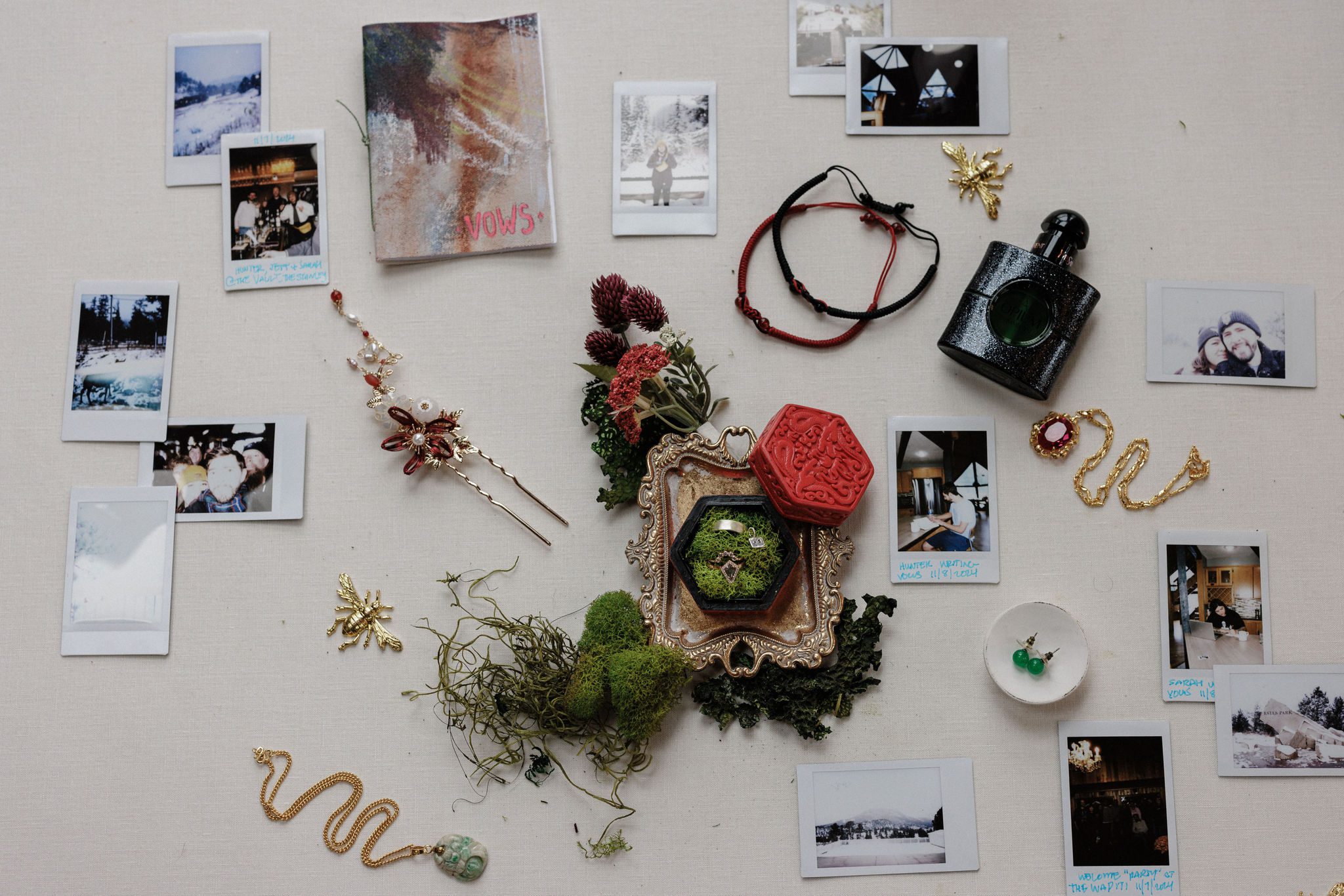 winter elopement details- wedding rings, red chinese trinket box, jade jewelry, chinese knot bracelets, and polaroid photos of bride and groom
