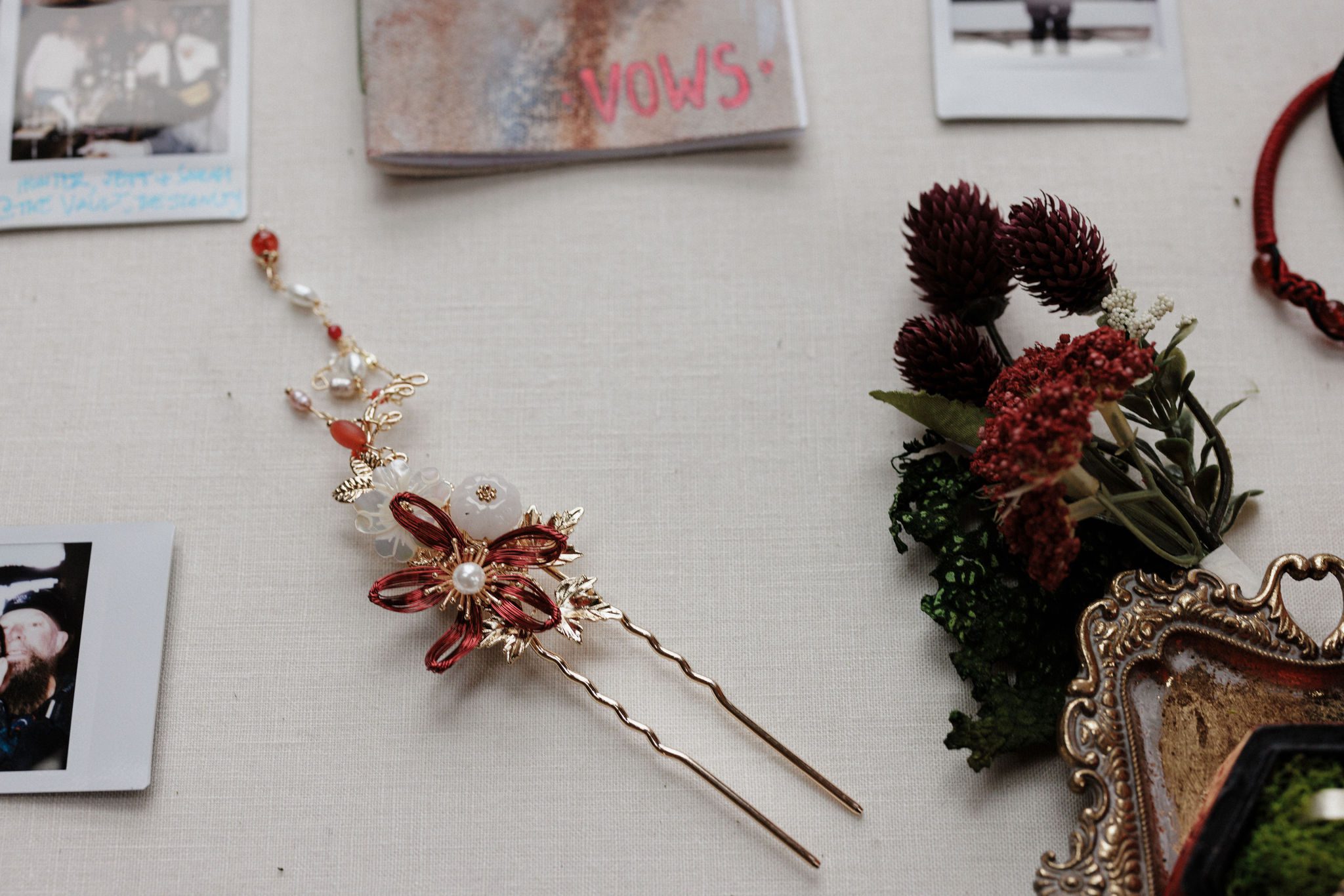 winter elopement details- handmade boutonniere with hair pin and vow book