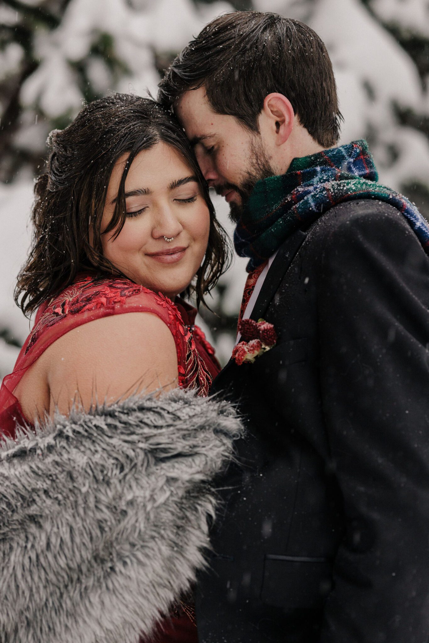 bride and groom pose for colorado photographer at rocky mountain national park after winter elopement ceremony