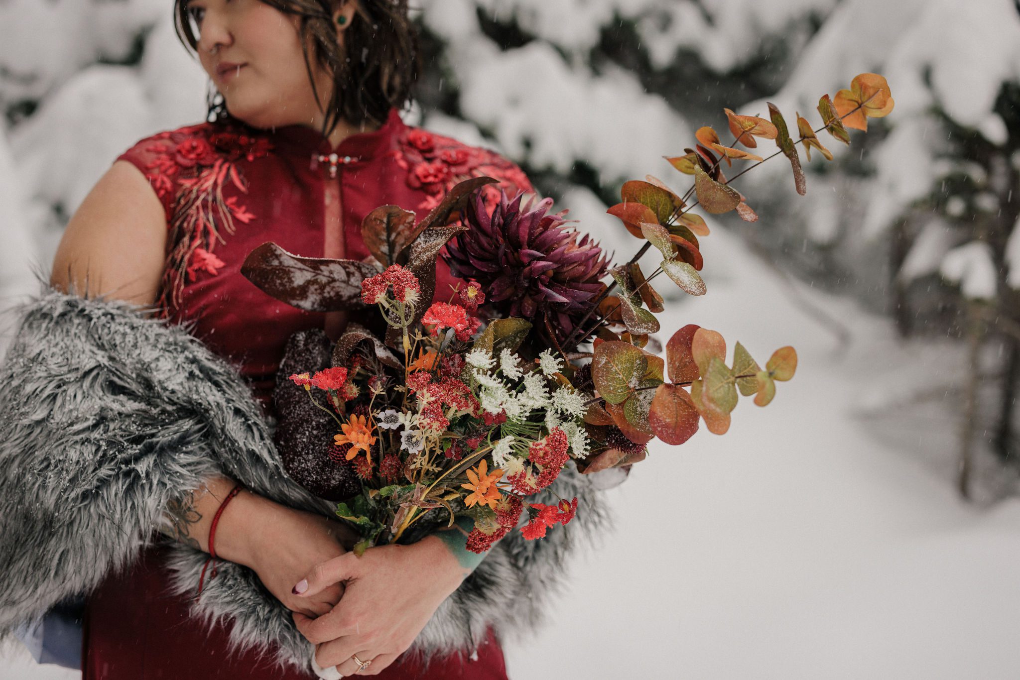 bride holds handmade bouquet during colorado winter elopement