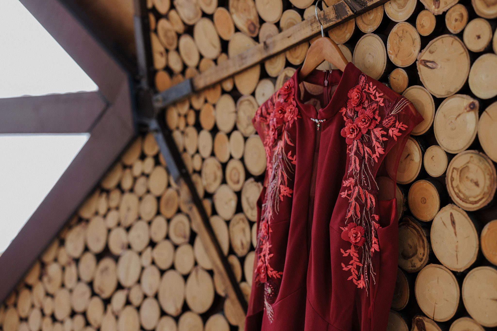 elopement dress hanging from wooden wall of colorado airbnb 